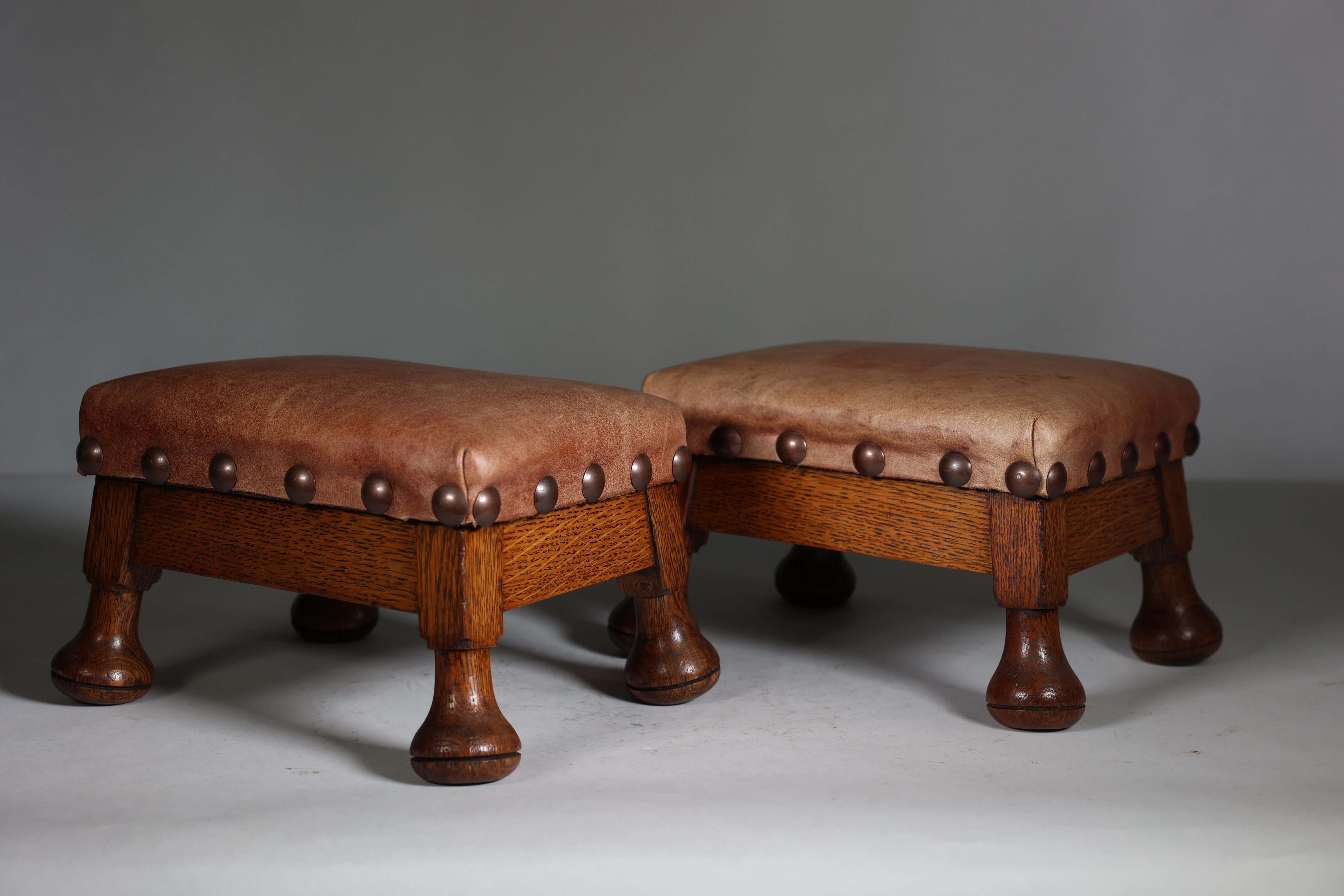 English A little pair of Aesthetic Movement oak Thebe stools with leather studded seats For Sale