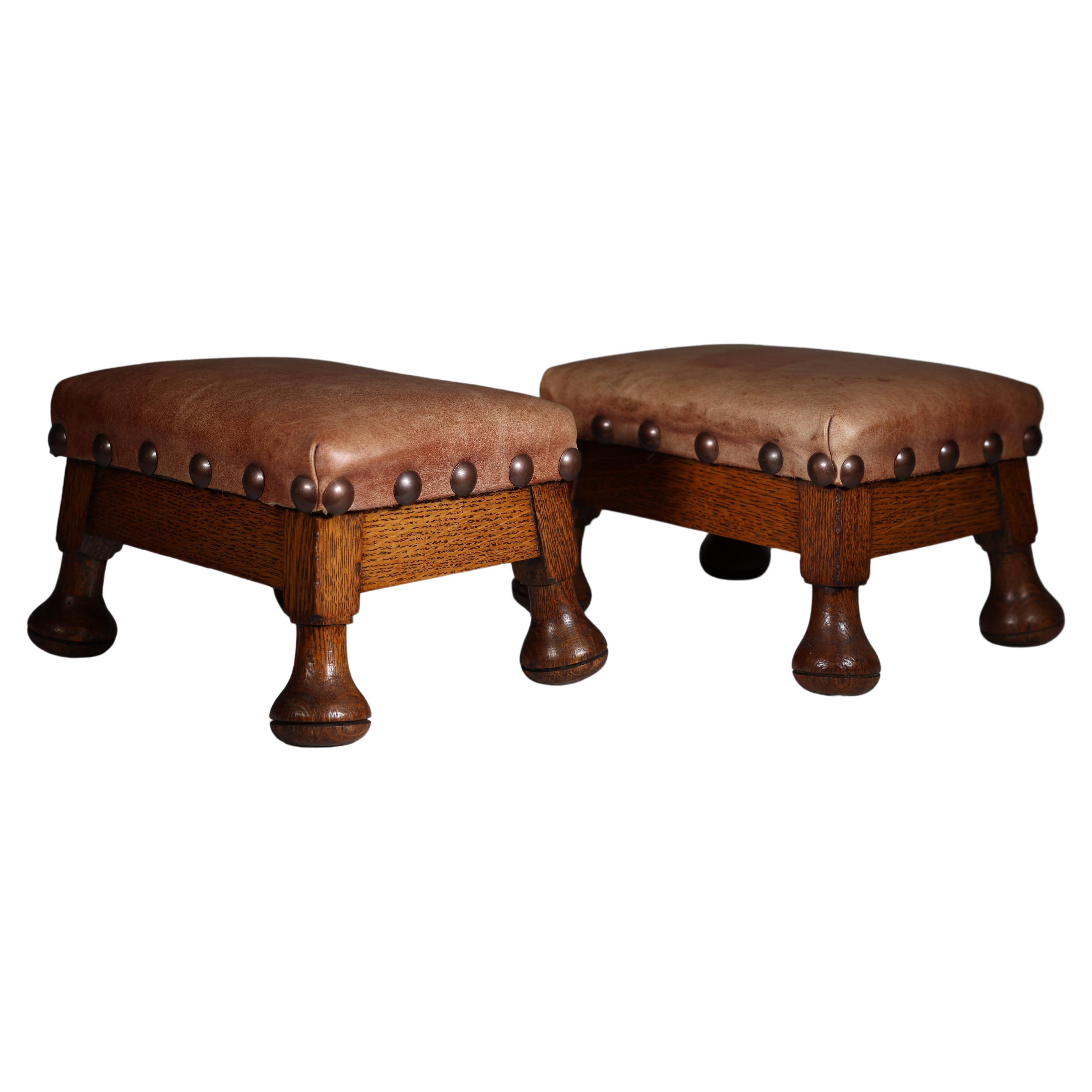 A little pair of Aesthetic Movement oak Thebe stools with leather studded seats For Sale