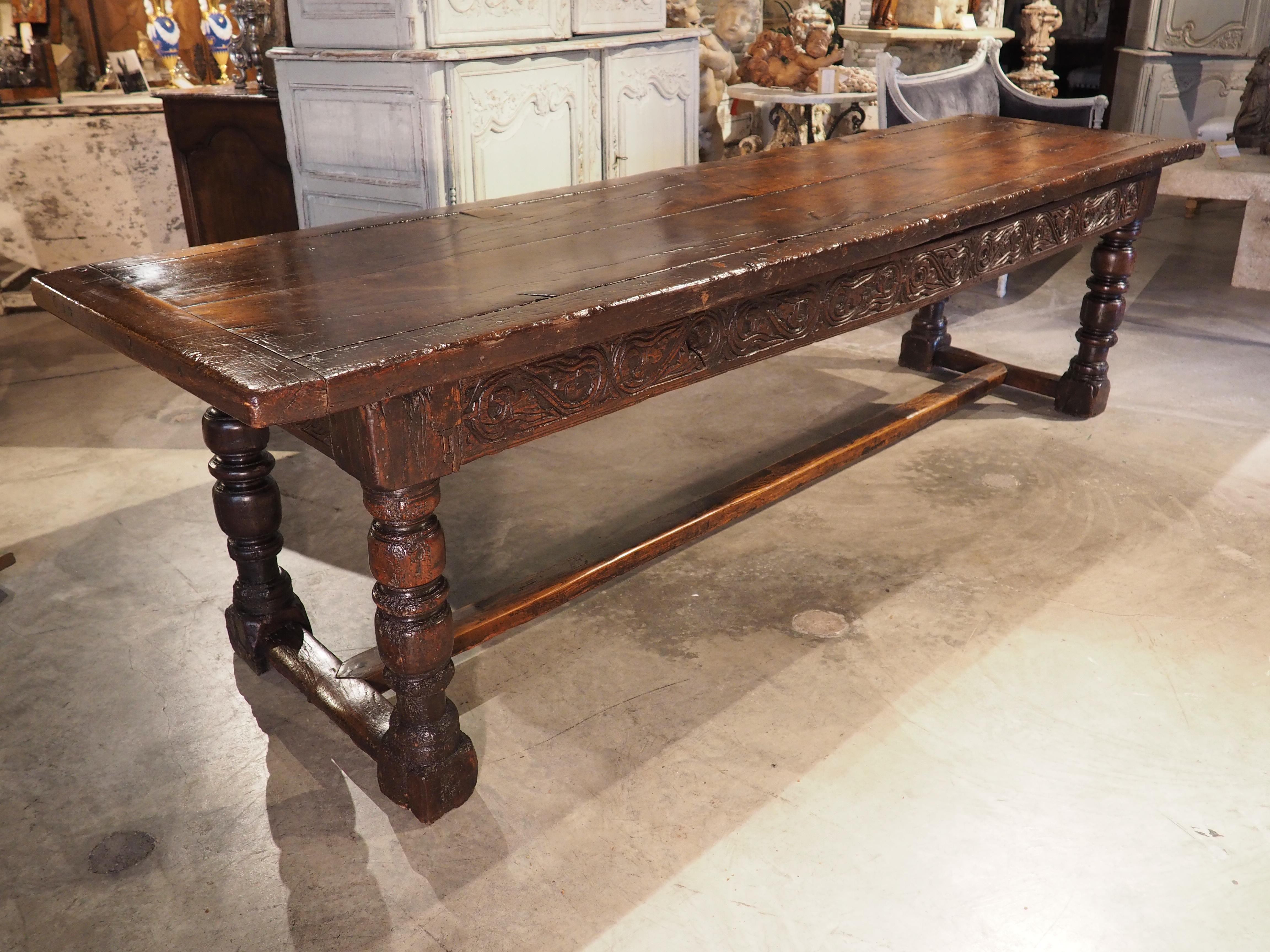 At over nine feet long, this sumptuous oak baluster leg table was hand-carved with an H-stretcher in Flanders, circa 1680. Long tables such as these were known as table de communauté and were designed to accommodate as many seats as possible.
