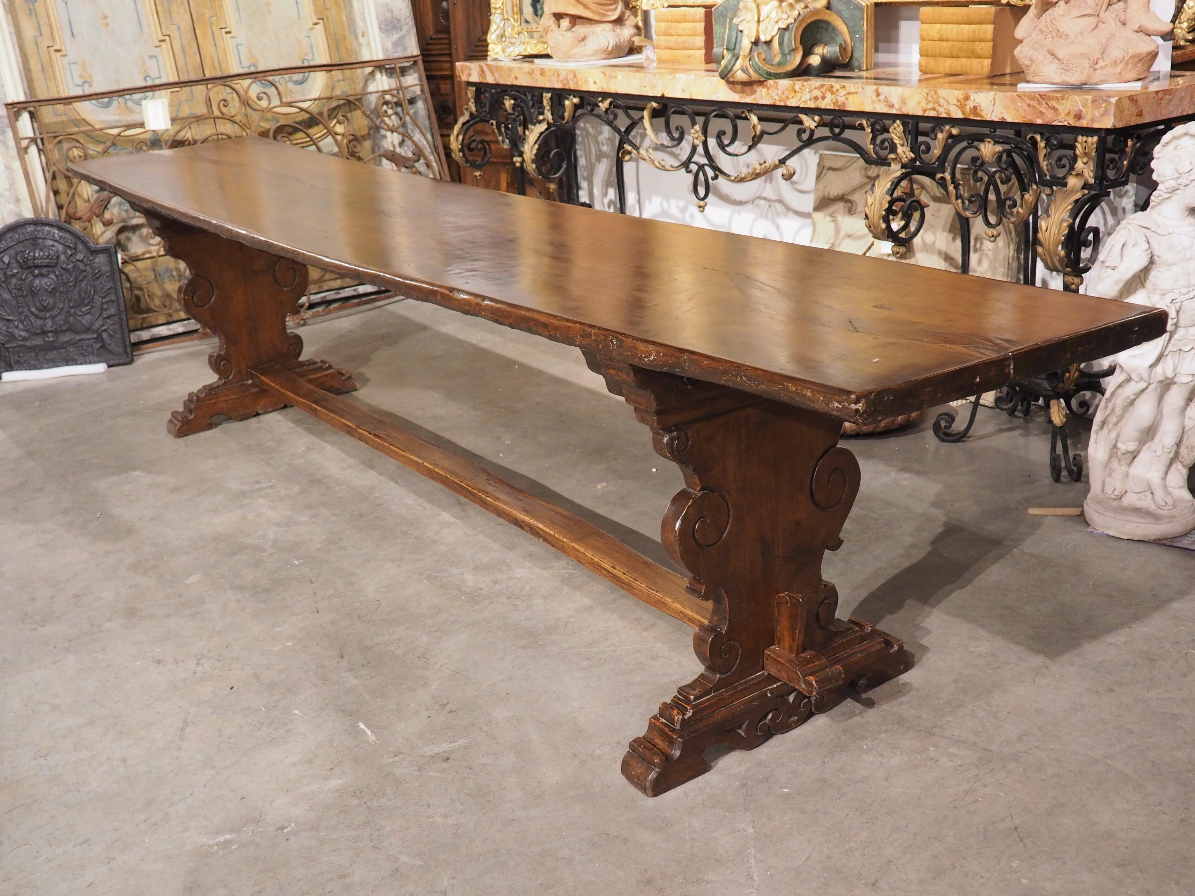 A rare single plank of walnut with extreme length (11 feet, 6 inches) forms the top for the refectory table from Northern Italy. Tables such as this were often used as dining tables for monks at monasteries. This beautiful example from Tuscany,