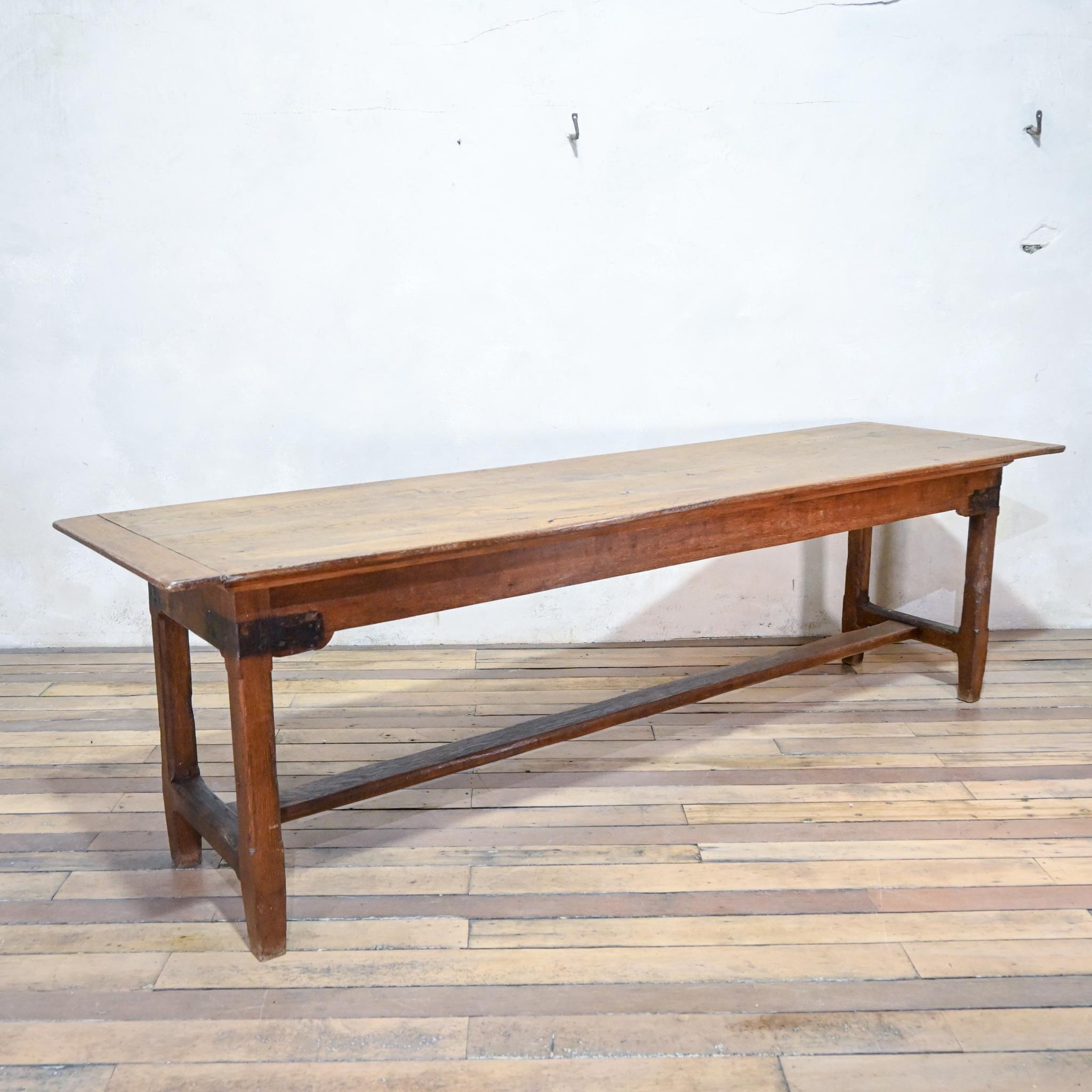 A long 19th century french oak farmhouse refectory table. A very architecturally pleasing design raised on slightly tapering legs. United by a central stretcher, which appears to have been replaced at some point during the mid 20th century.