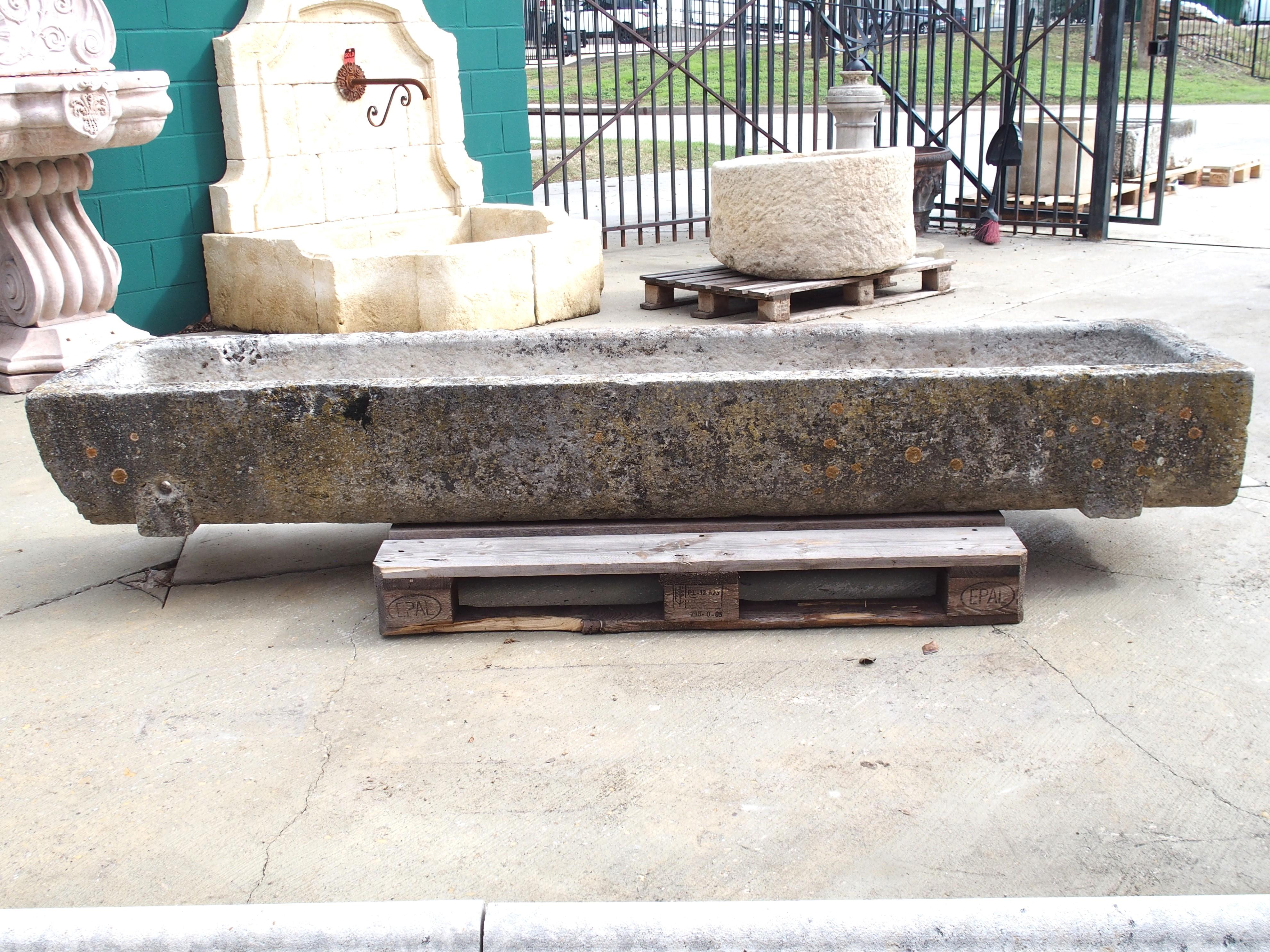 Hand-carved from one piece of stone in Burgundy, France, circa 1800, this trough is extremely long, with a length of 91 ½ inches! The gray stone has a magnificent patina consisting of a mottling of black, cream, and white, with traces of brown and