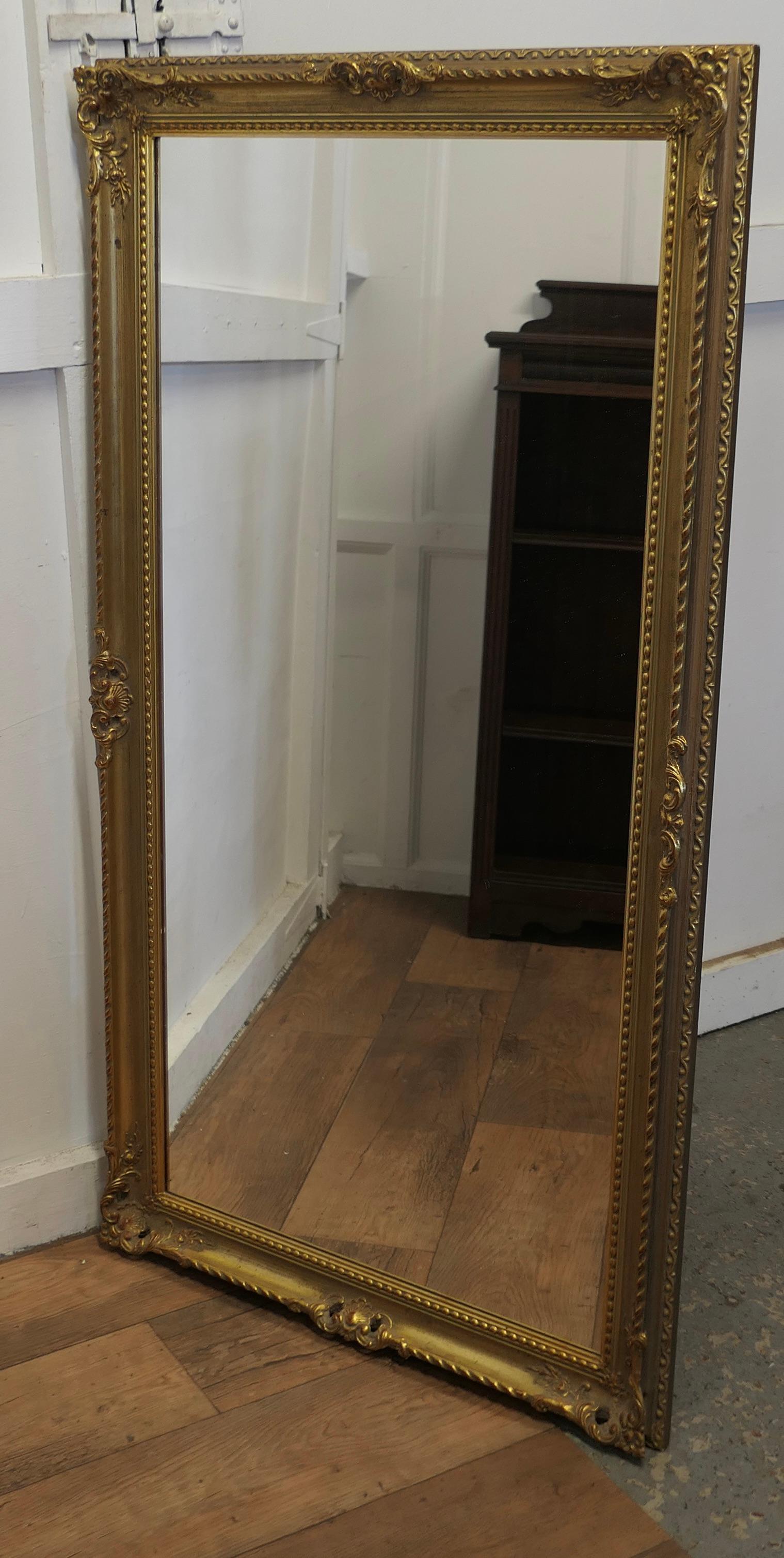 French Provincial A Long Decorative Gilt Wall Mirror  A delightful piece  For Sale