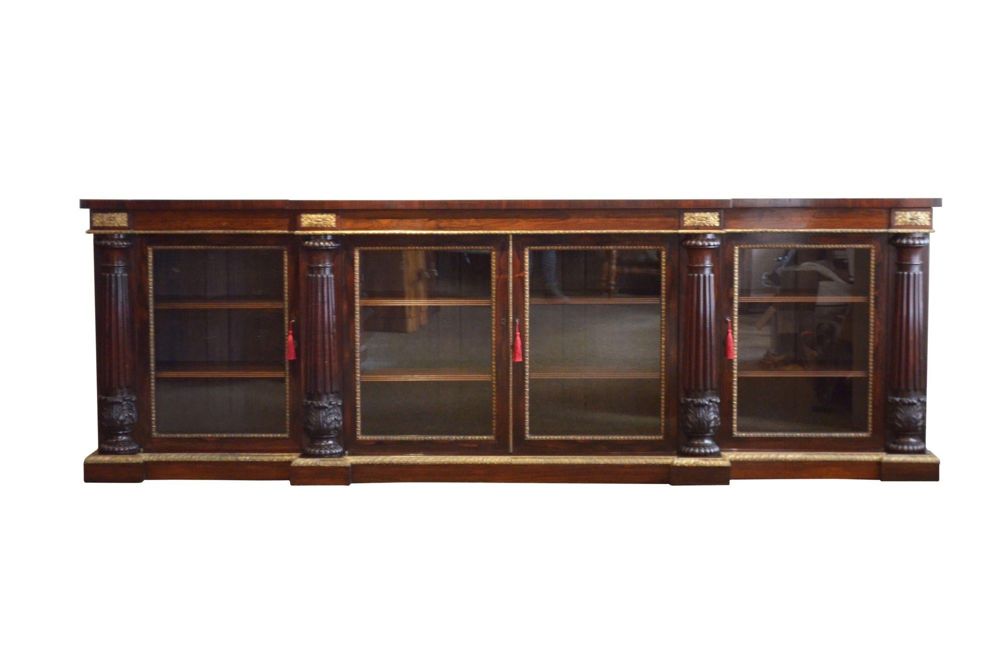 Sn5523 An exhibition quality George IV break fronted sideboard, having oversailing top with stunning figured grain above a shallow frieze with original ormolu pateraes and pair of central glazed doors enclosing simulated rosewood interior with four