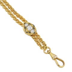 A long gold chain with diamond-set cursor