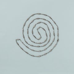 A long platinum art deco chain with diamonds