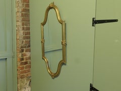 A Long Shaped Oval Brass Wall Mirror The Mirror has a decorative Acanthus Leaf