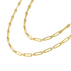 A long yellow gold paper clip chain