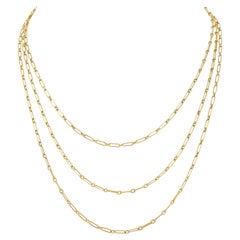 A long yellow gold paper clip chain