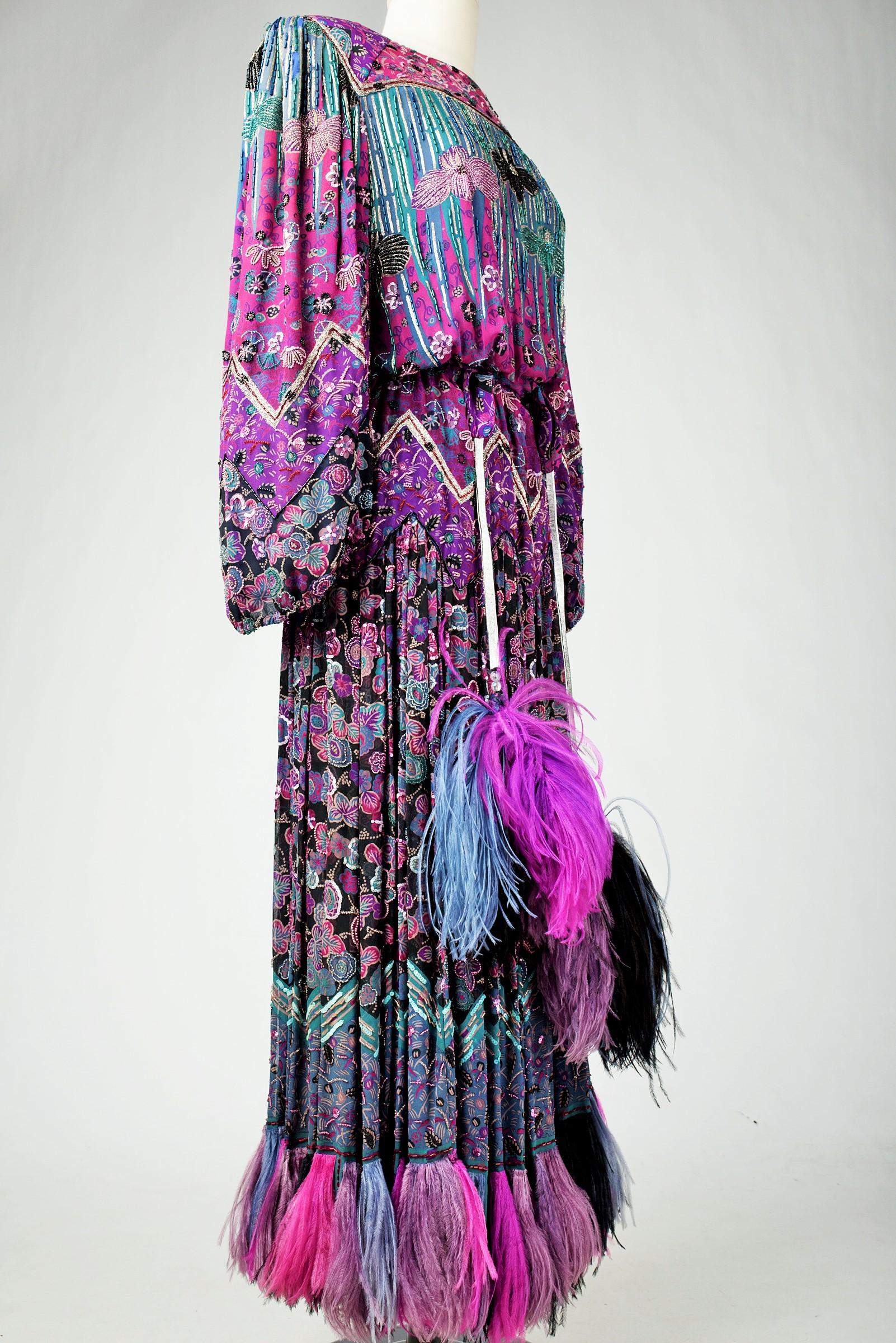 Fall Winter 1981-1982 Collection

France

Amazing evening dress in embroidered silk chiffon by Louis Féraud Haute Couture from the 1981-1982 collection. Loose blousante dress with puffed sleeves and epaulets, in silk chiffon densely embroidered with