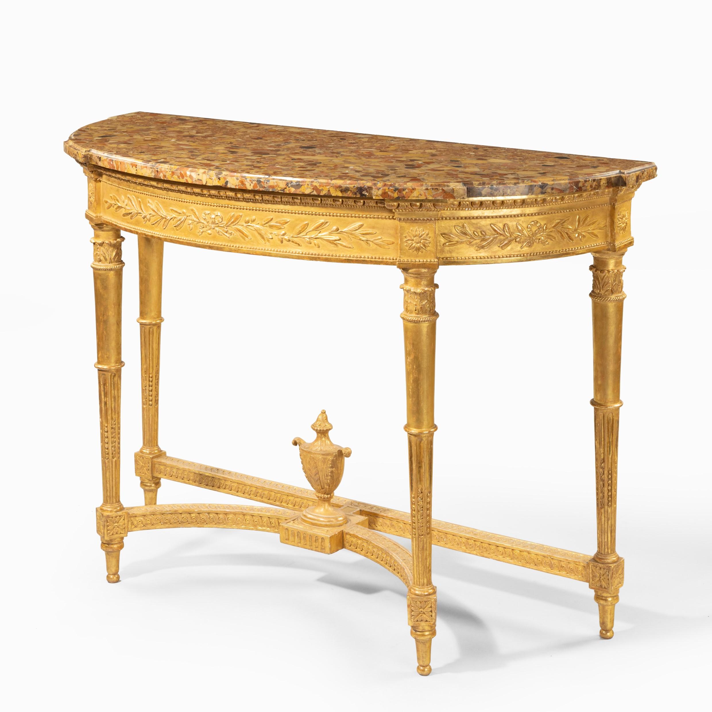 A Louis Philippe giltwood demi-lune console table, the original shaped breche d’Alep marble top set on a frieze carved with olive branches, the four tapering stop-fluted legs joined by a double guilloche carved stretcher centred on a classic urn,