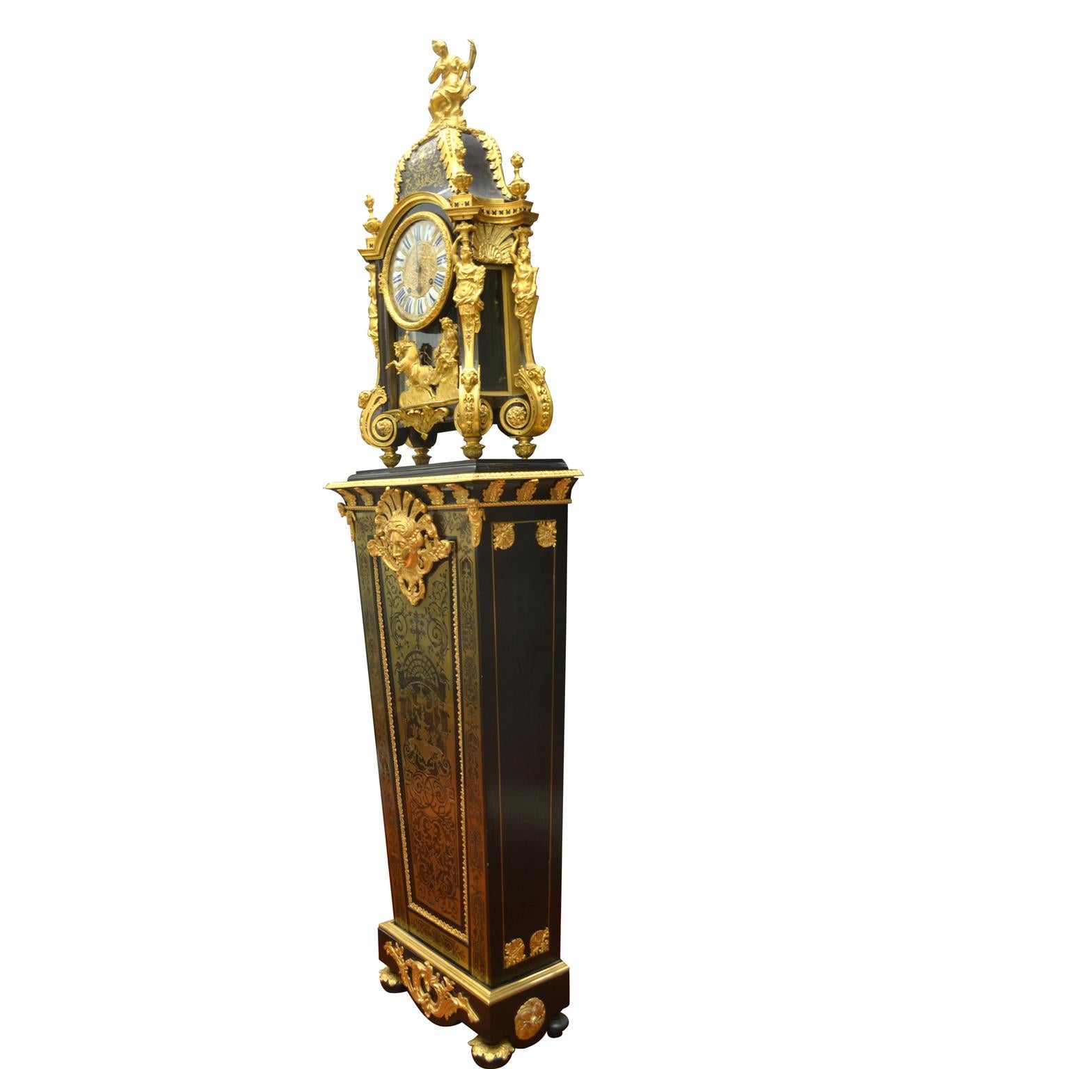 An exceptional 18 century Louis XIV Boulle clock and pedestal the movement signed Duval Paris for Gideon Duval., The circular dial with twelve individual enameled plaques with Roman numerals indicating the hours and Arabic numerals for the minutes