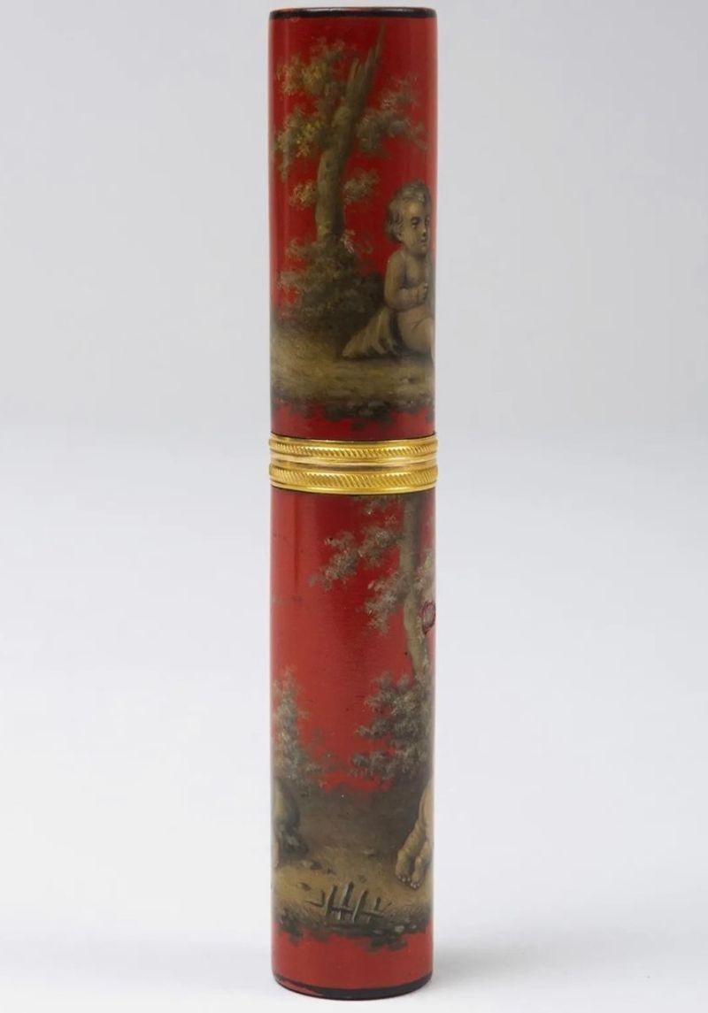 The etui painted decoration depicting Putti at play with grissaille decoration, with an 2 engine turned gilt bronze bands at join.