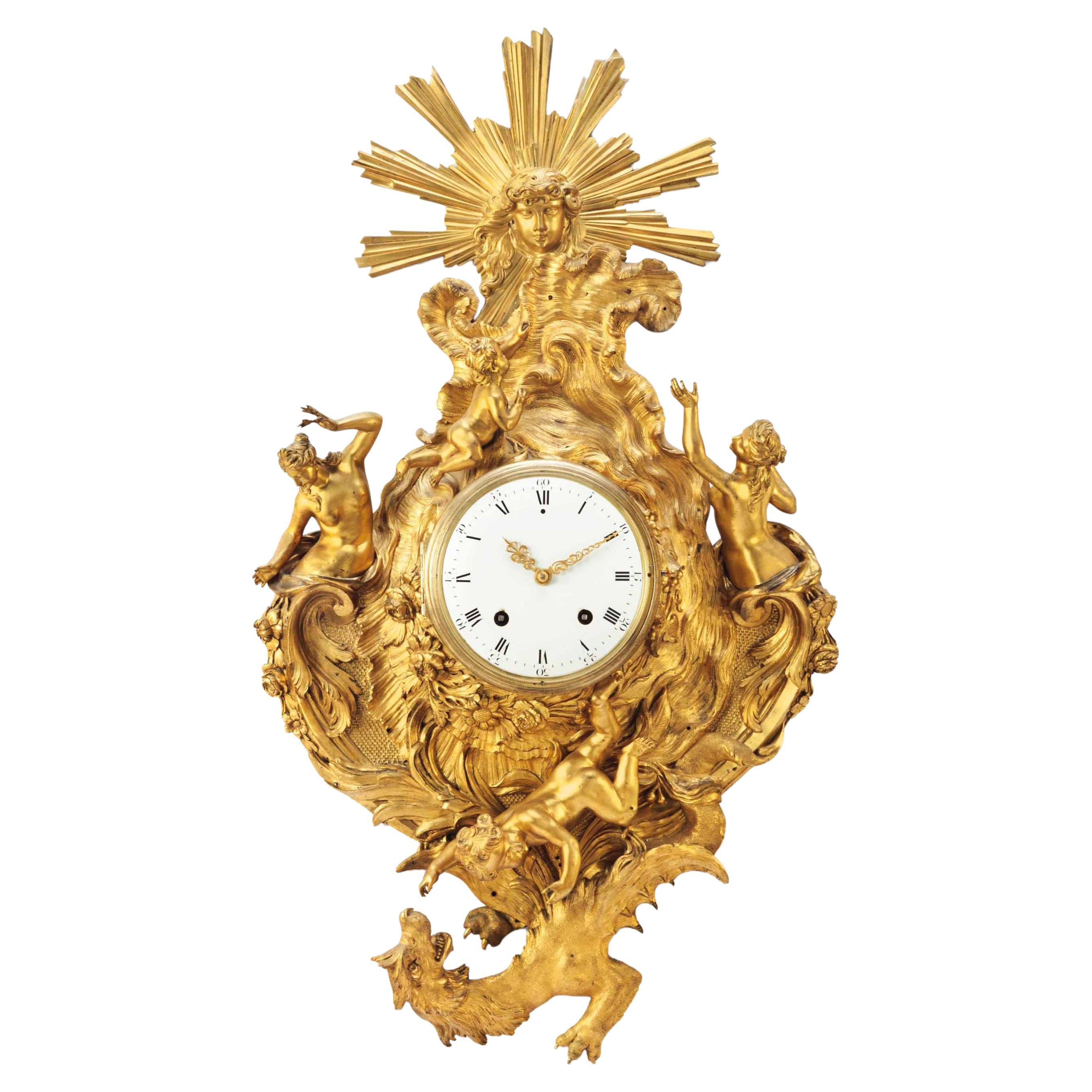 ITEM: A LOUIS XV ORMOLU CARTEL CLOCK
AUTHOR: CHARLES BALTHAZAR
PERIOD: APPROXIMATELY 1745
Dimensions:
40 ¼ in. (102.3 cm.) high, 23 in. (58.5 cm.) wide

 A mask of Apollo is on the top. The central part is an asymmetrical rockwork case within