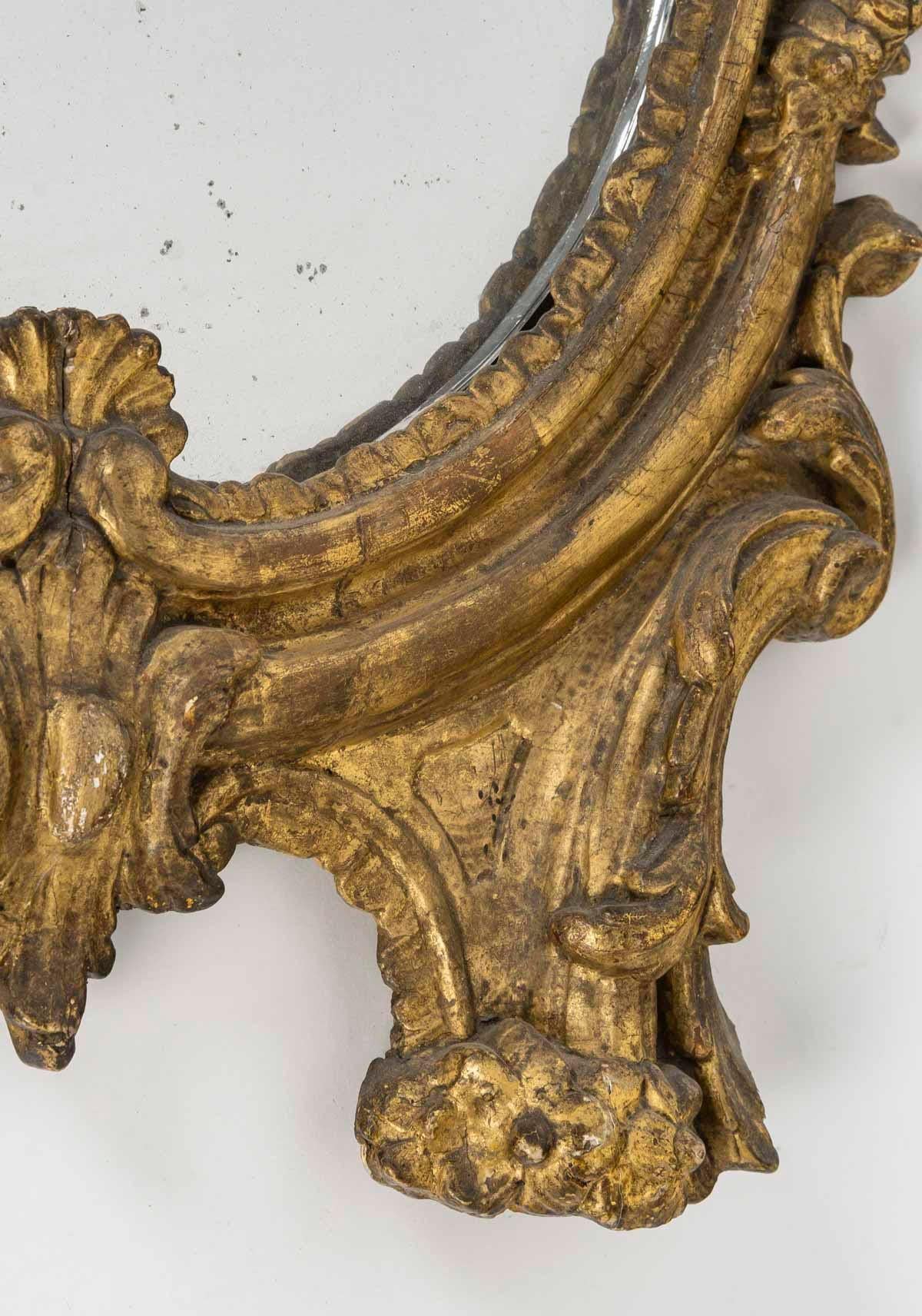 A Louis XV period carved and gilded wood wall mirror, 18th century.

A Louis XV period wall mirror, 18th century, carved and gilded wood, later mirror.
H: 58cm , W: 30cm, D: 5cm