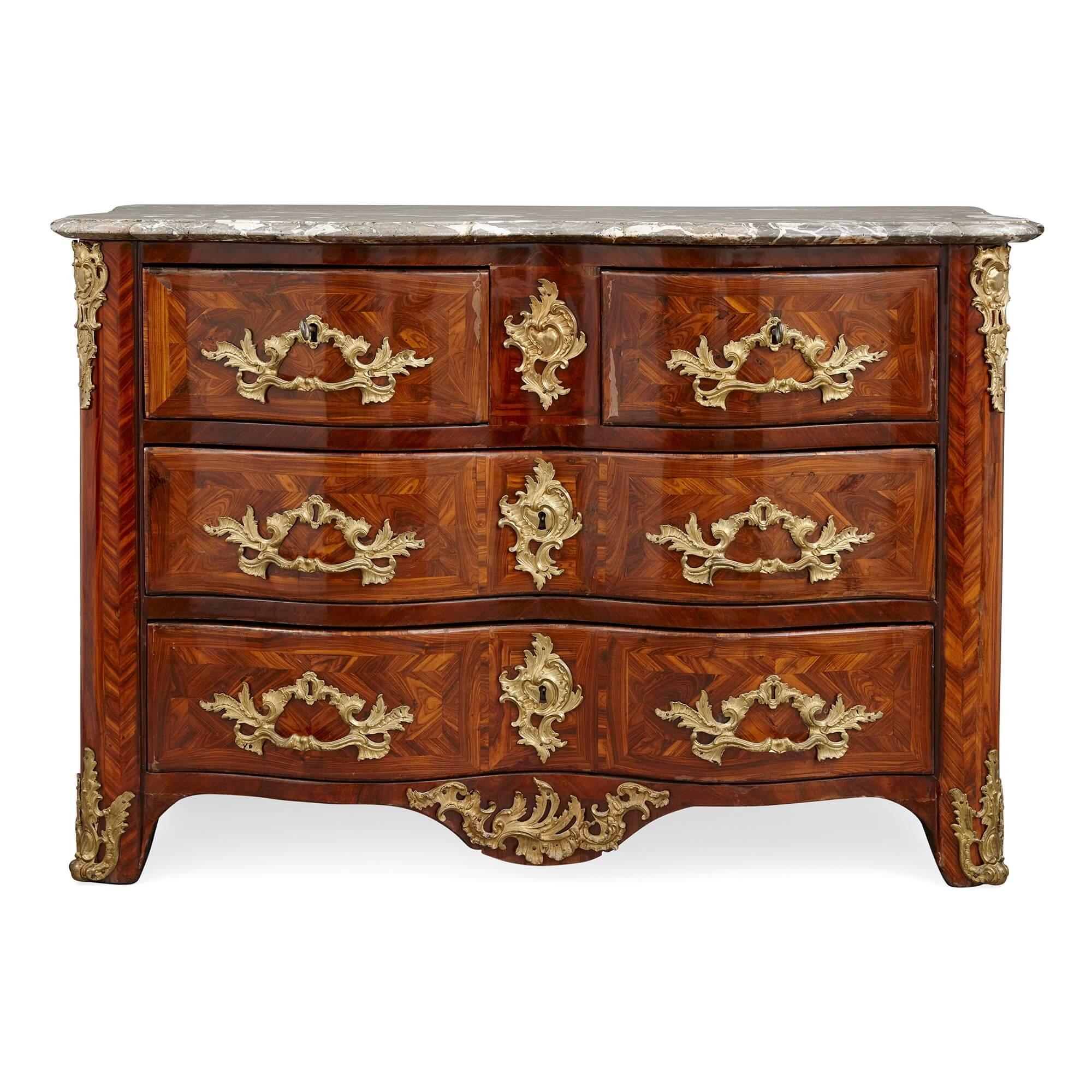 A Louis XV period ormolu and marble mounted commode.
French, 18th century.
Measures: height 84cm, width 122cm, depth 68cm.

With a veined grey marble top set above two small and two long drawers, and with a partial stamp and the letters 'JME,'