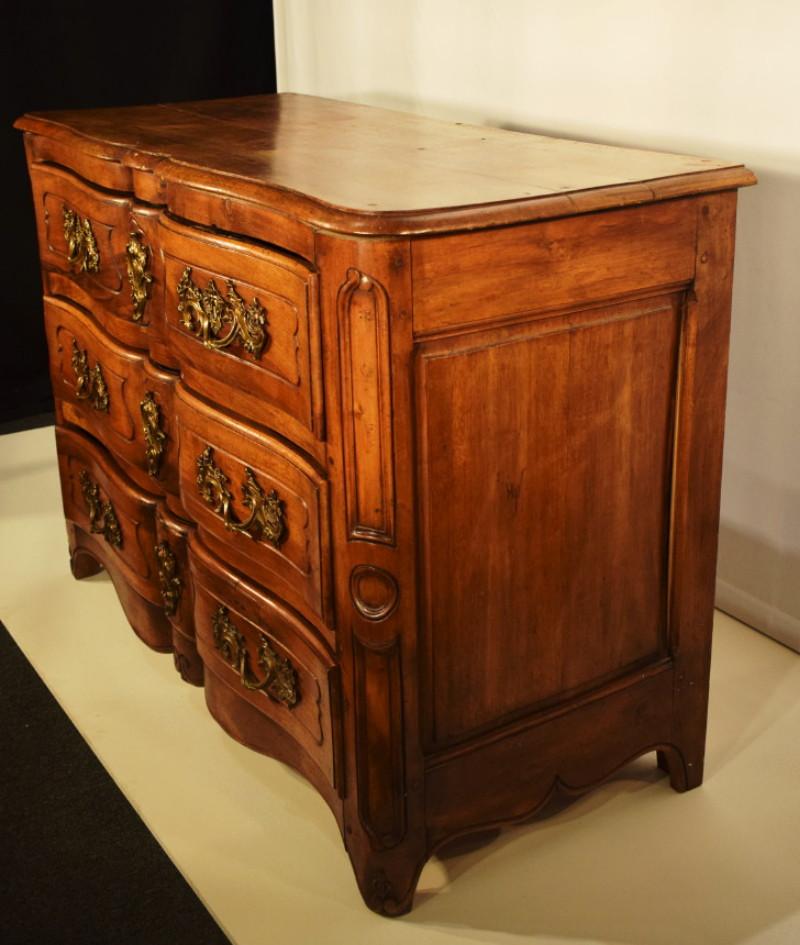 A Louis XV Provincial Walnut Commode. 18th century.
The serpentine-edged top above two short and two long drawers, the rounded stiles continuing to form the feet. Measures: Height 34 x length 47 1/2 x depth 21 1/4 inches.
CW4742