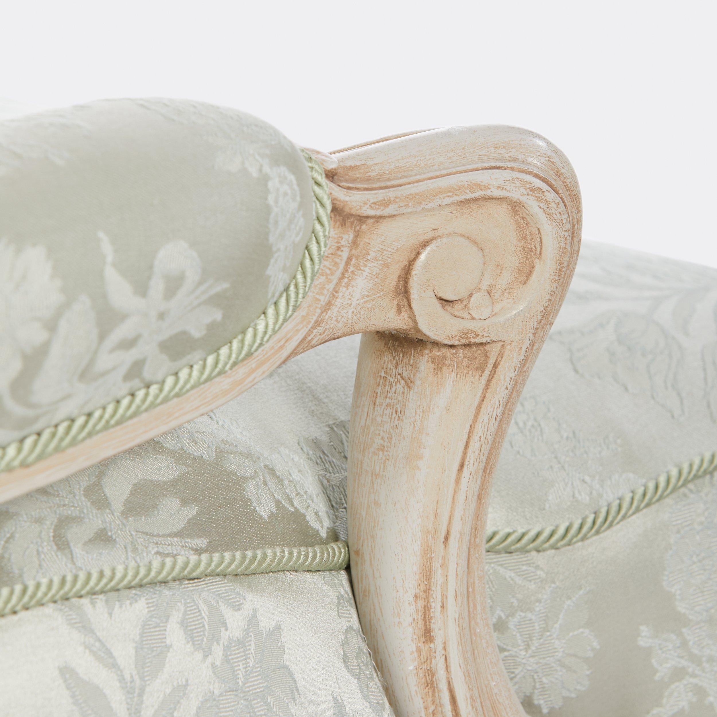 A bergere with brushed painted finish maple frame and light blue damask fabric and rope trim. The original model is based on a design by Syrie Maugham, English society decorator and wife of Somerset Maugham, which was provided by The Reader’s Digest