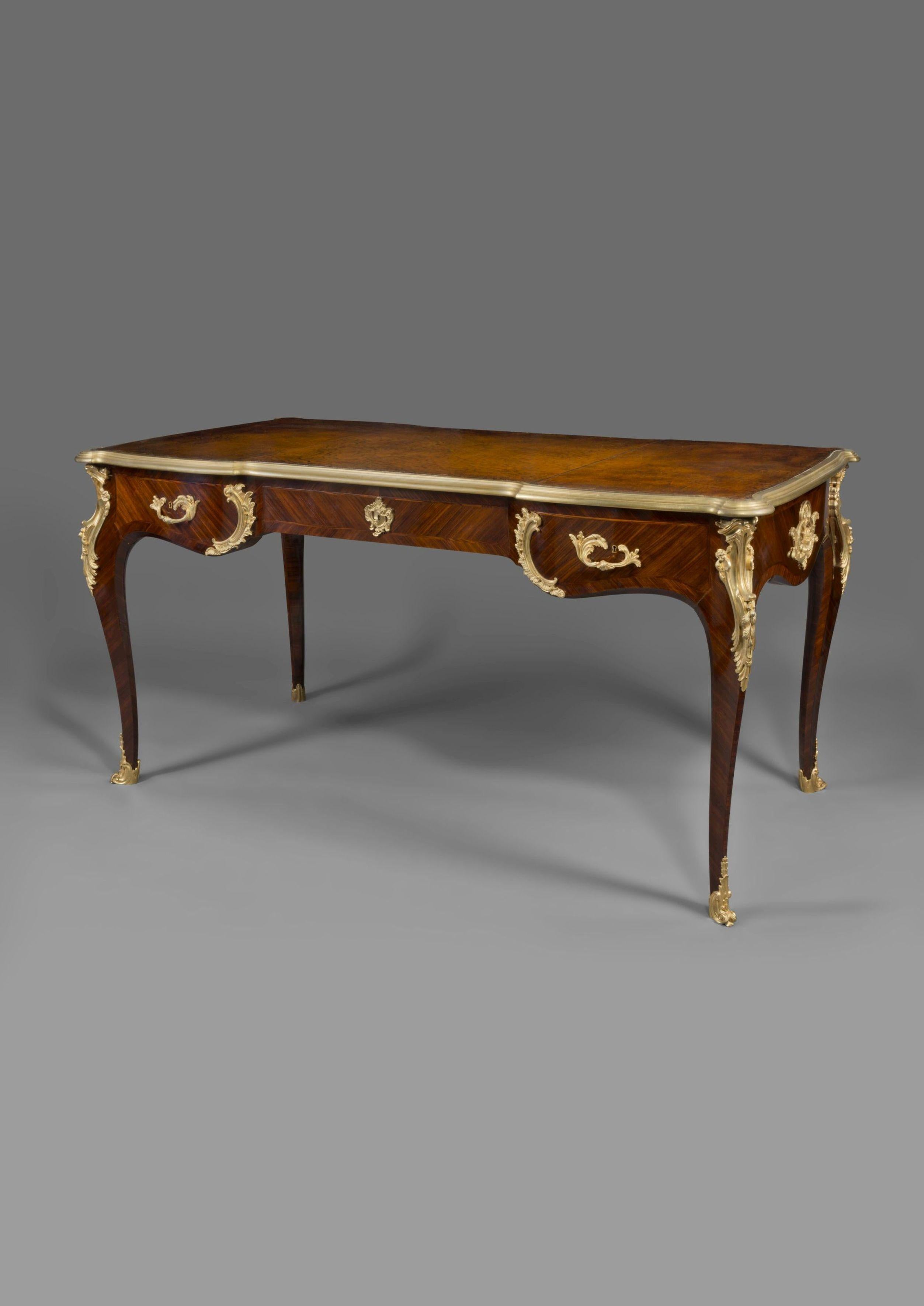 A Louis XV style gilt-bronze mounted bureau plat in the manner of Charles Cressent.

French, circa 1890. 

With one central frieze drawer and two shaped end drawers, on cabriole legs with scrolled foliate sabots

Charles Cressent (1685-1768)