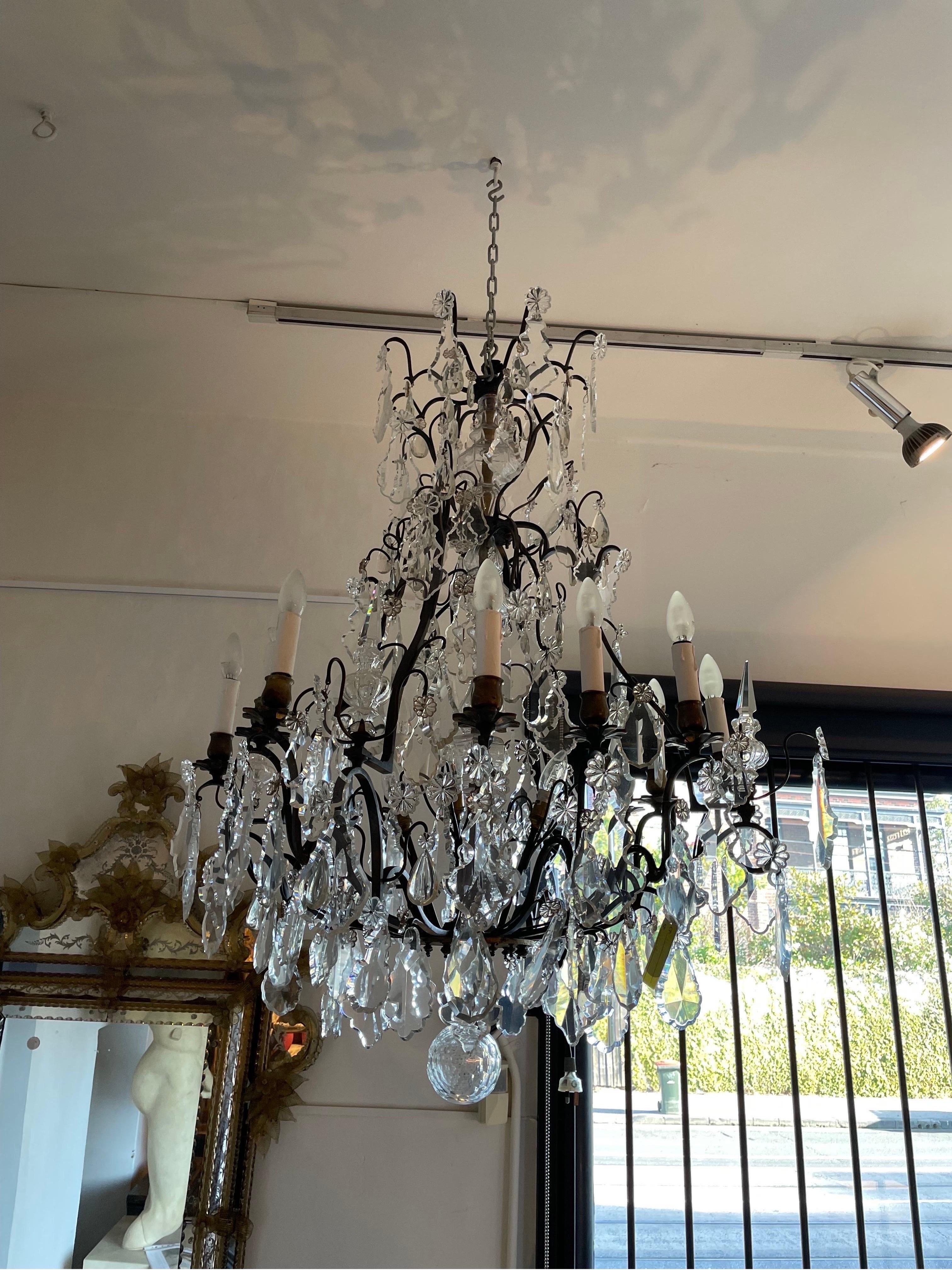 A Louis XV Style Cut Glass Chandelier, Late 19th Century / Early 20th Century

with a faceted glass pendant hanging from the center.

Provenance: Private Melbourne Collection.
