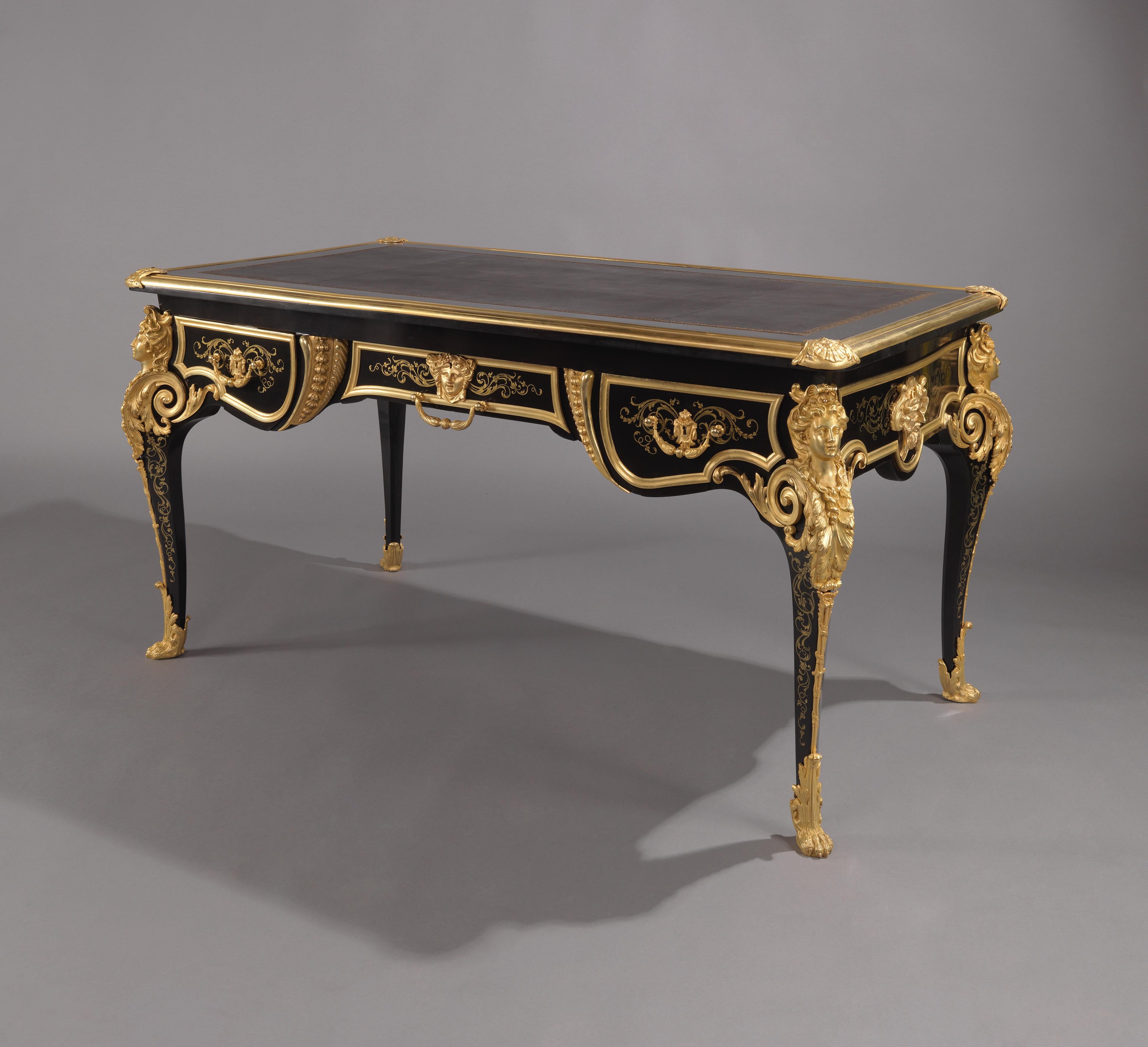 A fine Louis XV Style gilt-bronze and brass inlaid ebonized bureau plat, attributed to Befort Jeune.

French, circa 1870. 

The bronze mounts stamped to the reverse ‘BF’ and numbered ‘162’ or ‘92’.

This striking ebonised and gilt-bronze