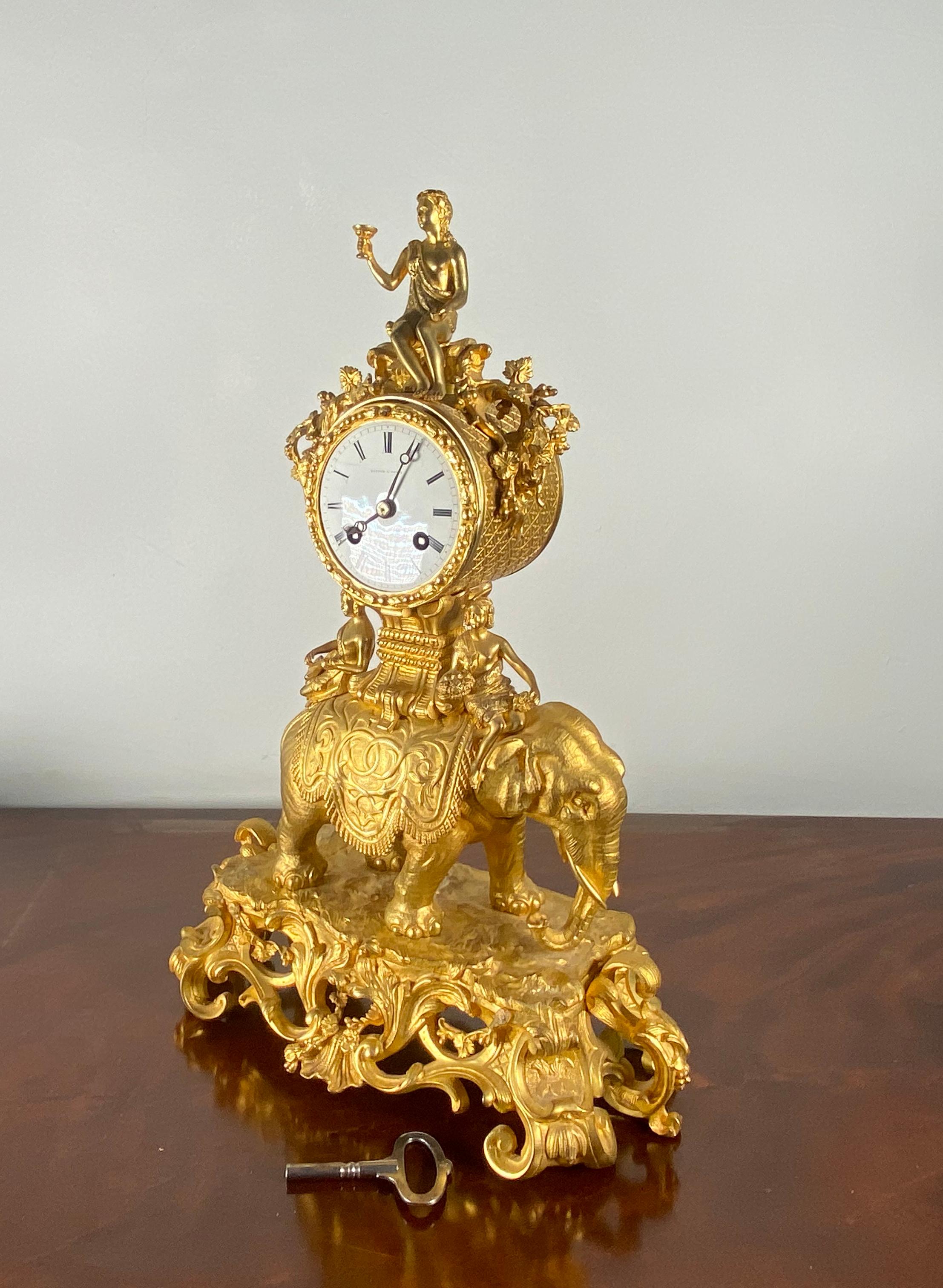 A wonderful mid 19th century Empire Clock
having white enamel dial with Roman numerals, the dial signed 'Hatton A Paris' surmounted and flanked by female figures, on a rocaille base.