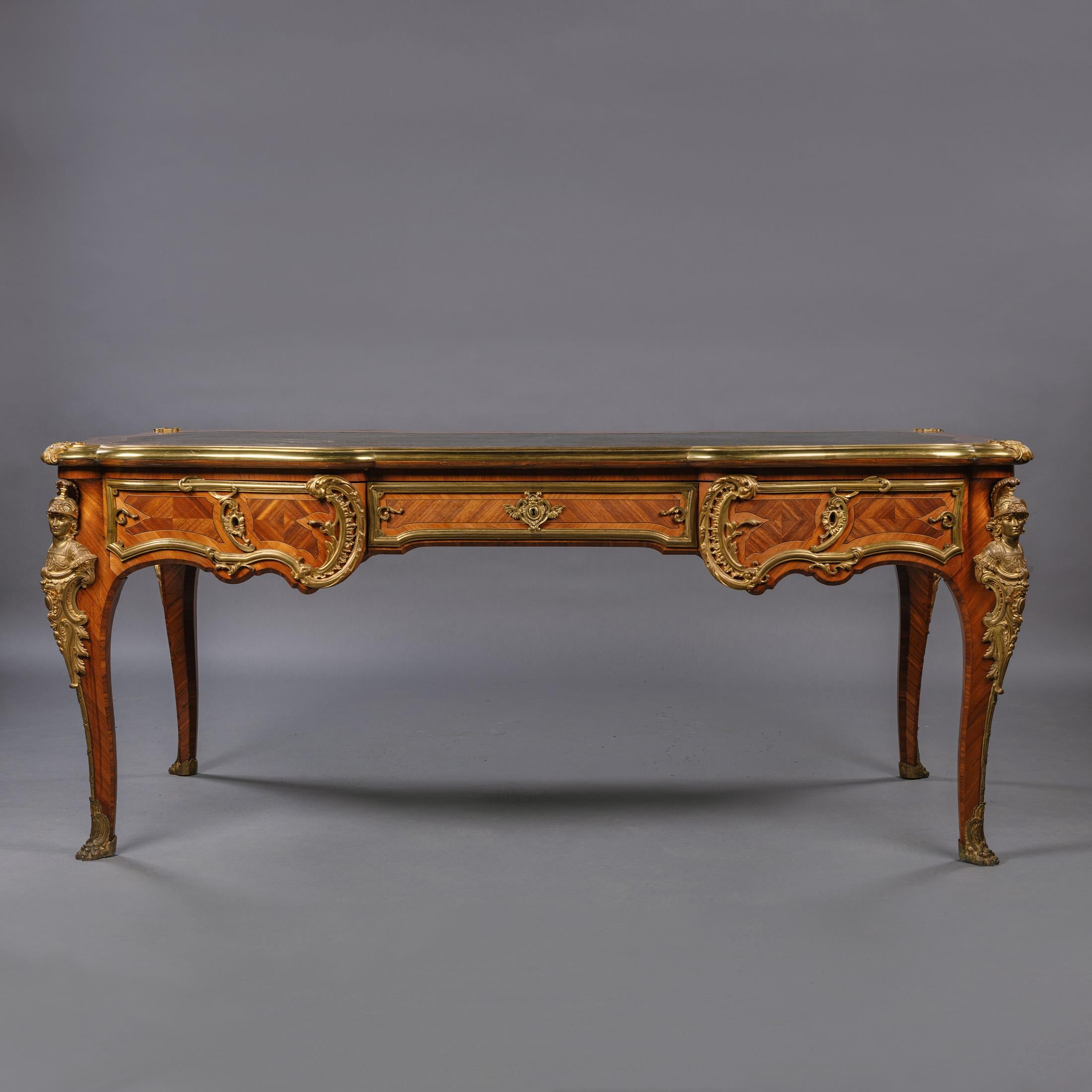A Louis XV Style gilt-bronze mounted bureau plat by François Linke.

The rectangular top inset with a green leather writing surface with gilt-tooled border, within a gilt-bronze surround above three frieze drawers, the back with simulated drawers,