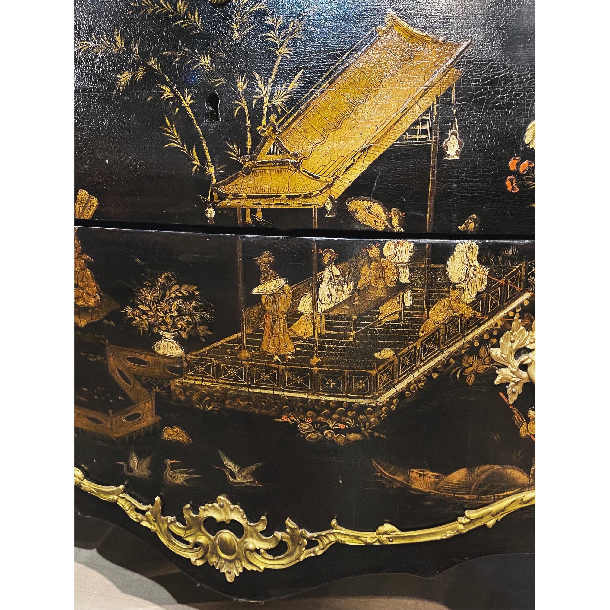 This Louis XV style gilt-bronze mounted lacquer commode contains a beautiful lake scene painted in chinoiserie style depicting people in a Chinese garden surrounded by a lake, small islands, a trio of cranes and lush nature. The scene is dotted with