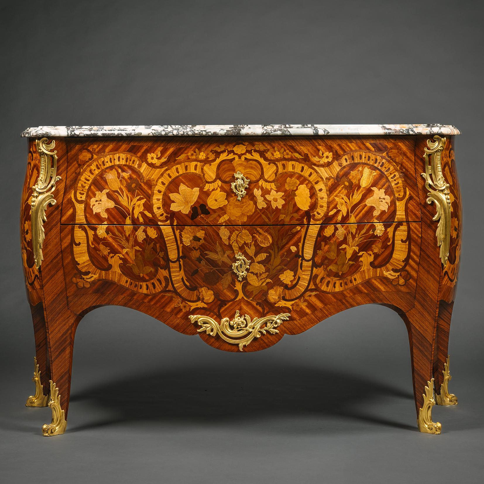 A Fine Louis XV Style Gilt-Bronze Mounted Marquetry Commode, By Paul Sormani, Paris. 

The finely proportioned bombé-shaped commode is veneered with floral marquetry in precious timbers. The original grey veined brêche marble top has a serpentine
