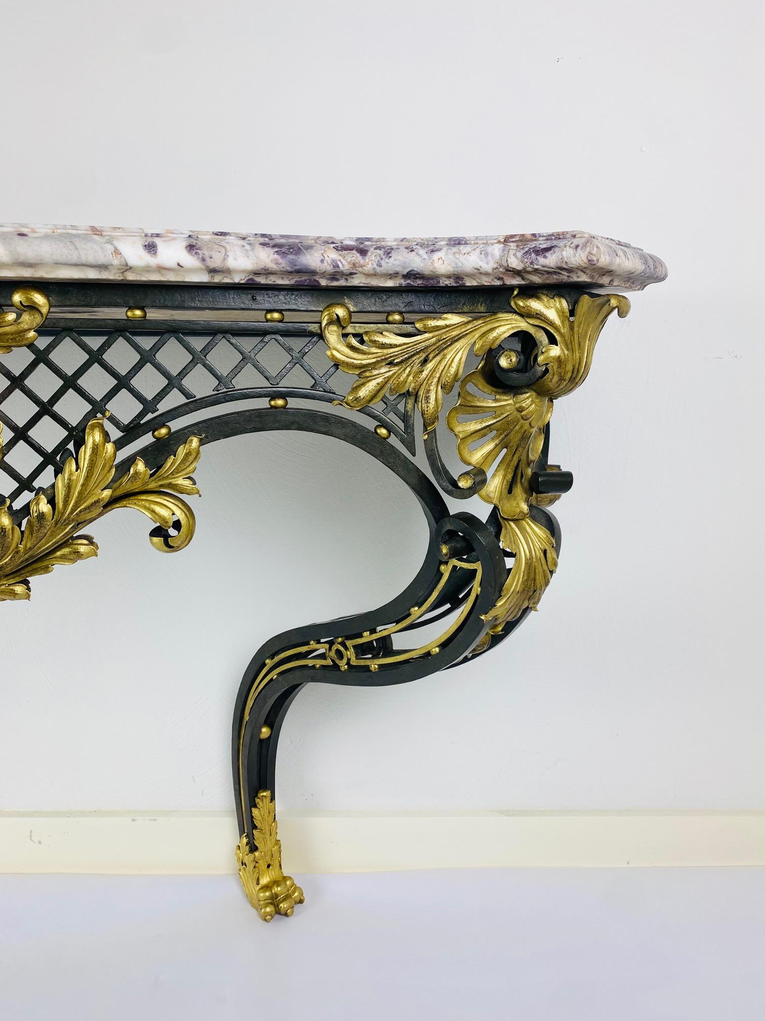 Late 19th Century A Louis XV style iron console with breccia violet top. For Sale