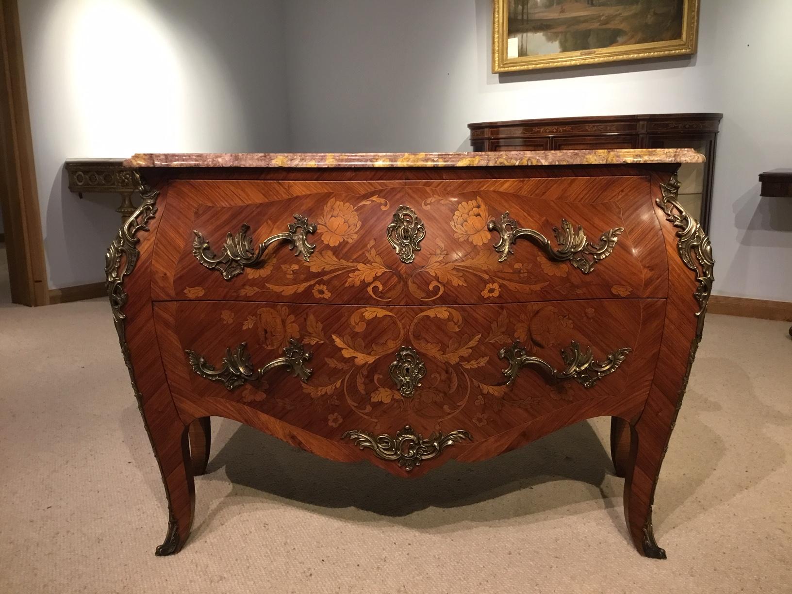 A Louis XV style kingwood, marquetry and ormolu-mounted French commode. The serpentine shaped 