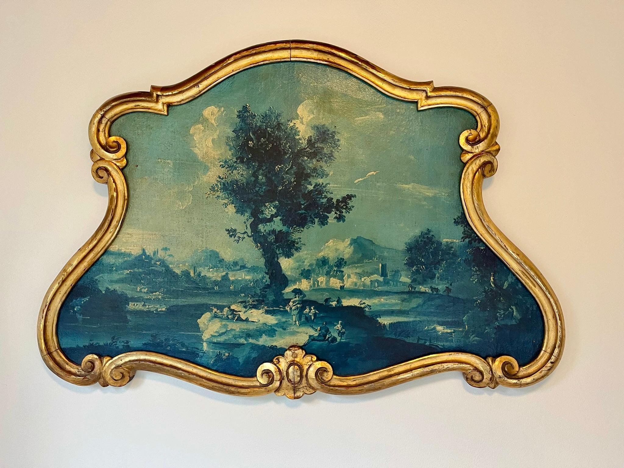 An antique giltwood encased French landscape as an overdoor . Carved French giltwood frame of cartouche form around a blue ‘ en grisaille ‘  landscape . 

Possibly part of a room boiserie originally and later converted as a hanging . Meant to hang
