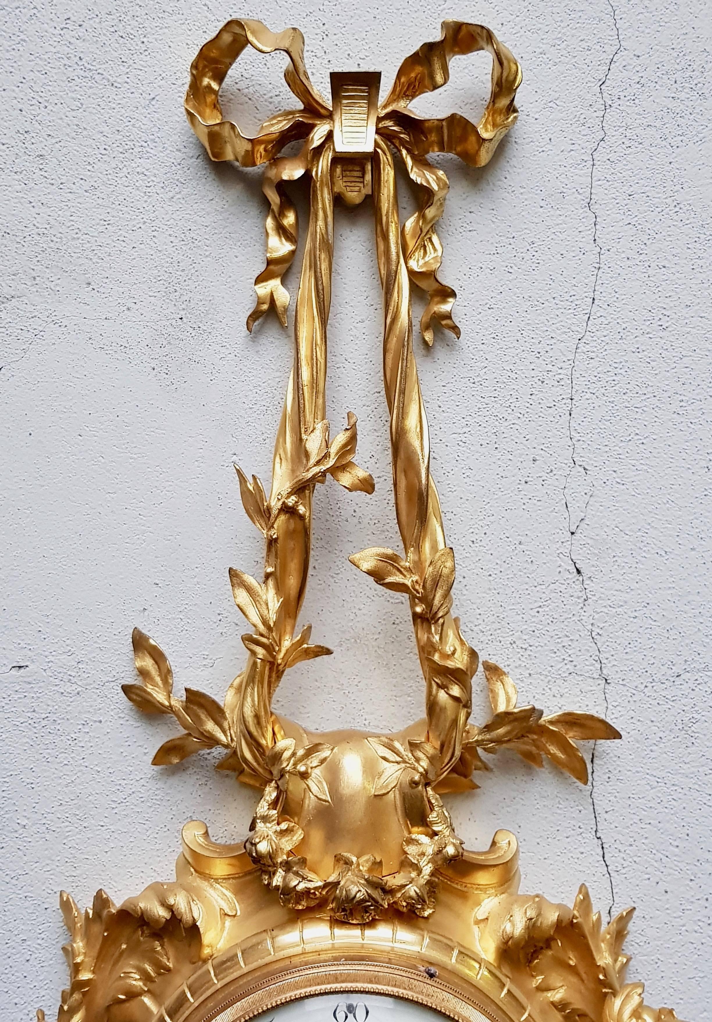 A Louis XV style ormolu Cartel clock, 19th century
Suspend by Laurel and Floral Garlands and flanked by Cornes d'Abondance
with enameled dial painted.
The pendulum with a Paris Mouvement , working and with its original key and pendulum.

The