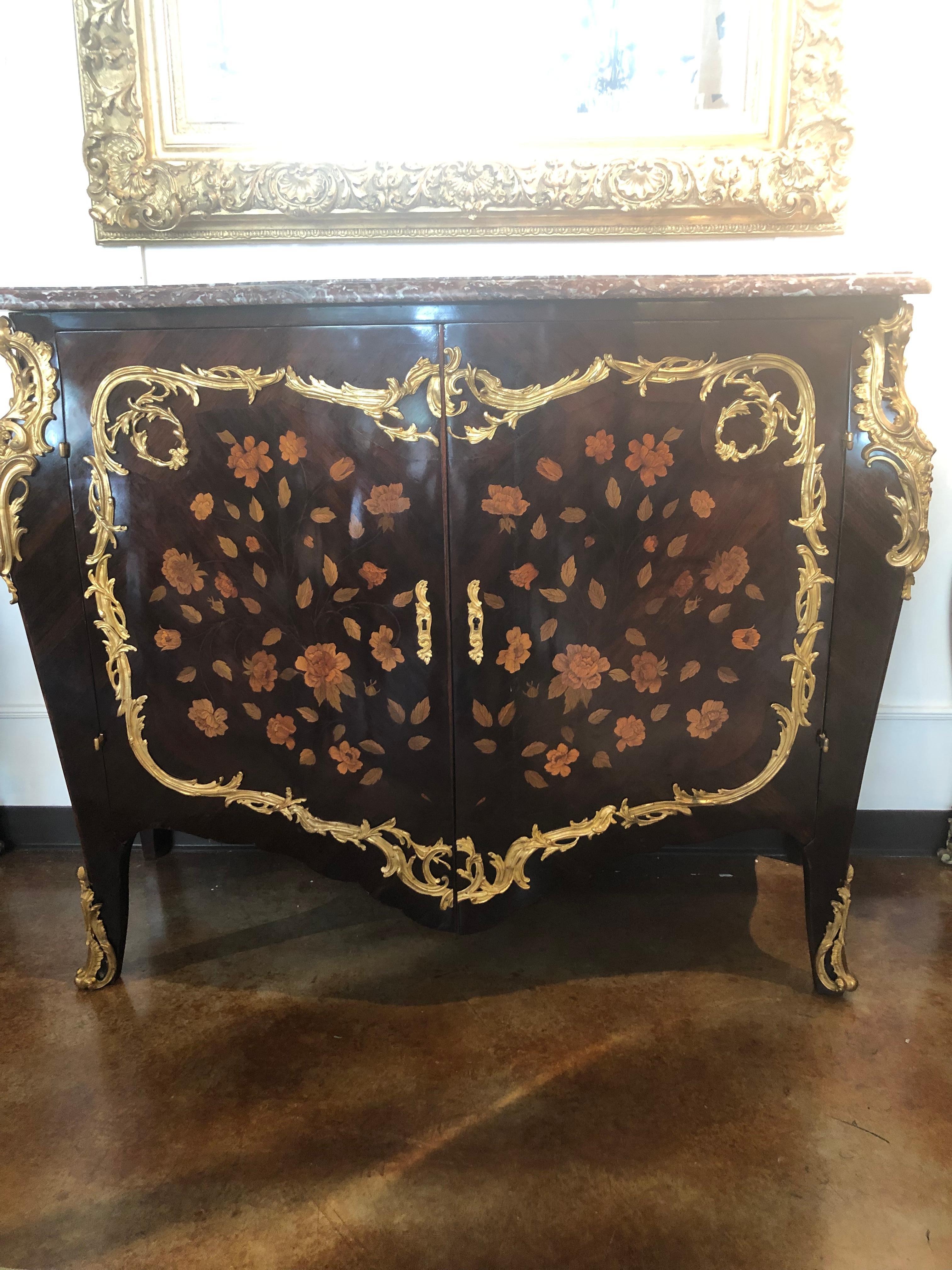 Exceptional French cabinet with floral and foliate
marquetry inlay with gilt bronze mounts.
two doors open at the front and interior has
one shelf. Sides are shaped and floral marquetry
decorations are enclosed by a frame of Doré