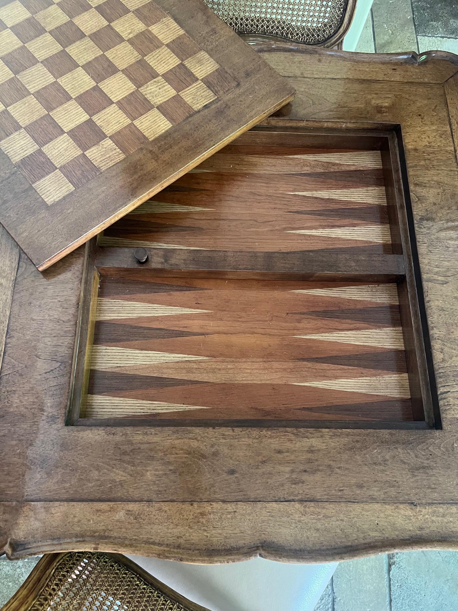 Louis XV style stained wood games table with cabriole legs and rounded corners. At the center is a chess/checkers board which pops up with a lever from the bottom. Inside is storage and a backgammon board.

Table: 36 wide by 29.5 tall

Can pickup