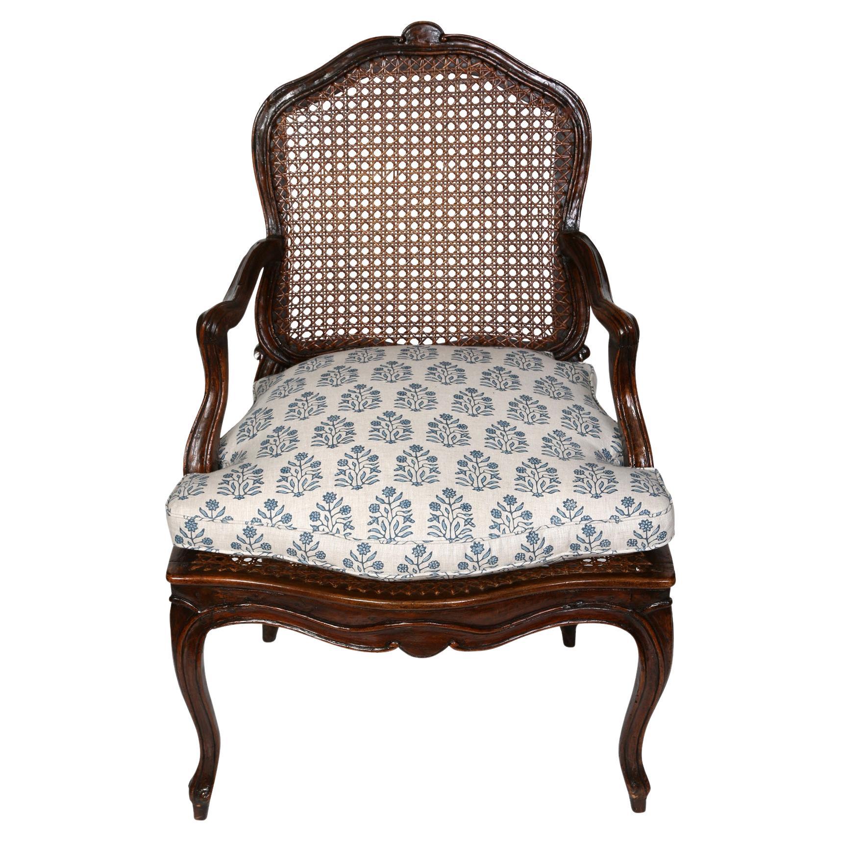 A Louis XV Style Walnut Chair with a Caned Back and Seat For Sale