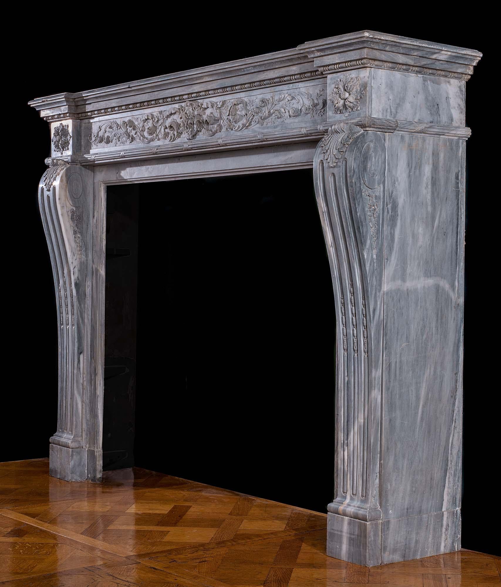 A very fine Louis XVI antique chimneypiece in a lightly veined, soft grey Bardiglio marble. The stepped shelf, with a bead and reel under band, rests on a beautifully carved foliate frieze of scrolling acanthus leaves framing a small floral
