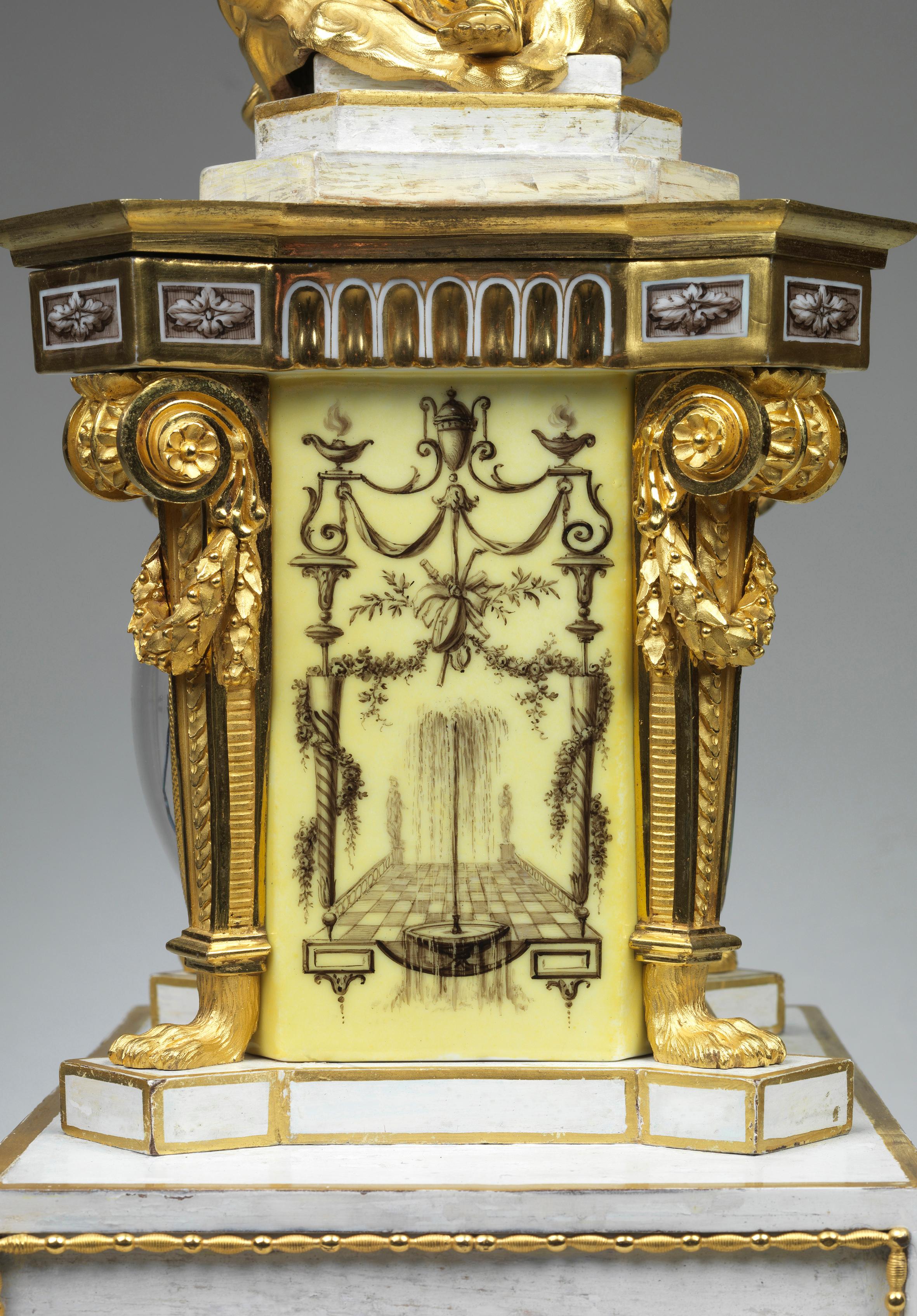 On a rectangular painted base, set on four ormolu feet, with an ormolu mounted yellow porcelain case, with white enamel dial signed by Lesieur a Paris. Above the case sits a stepped rectangular painted hood, with a figure of a woman in ormolu,