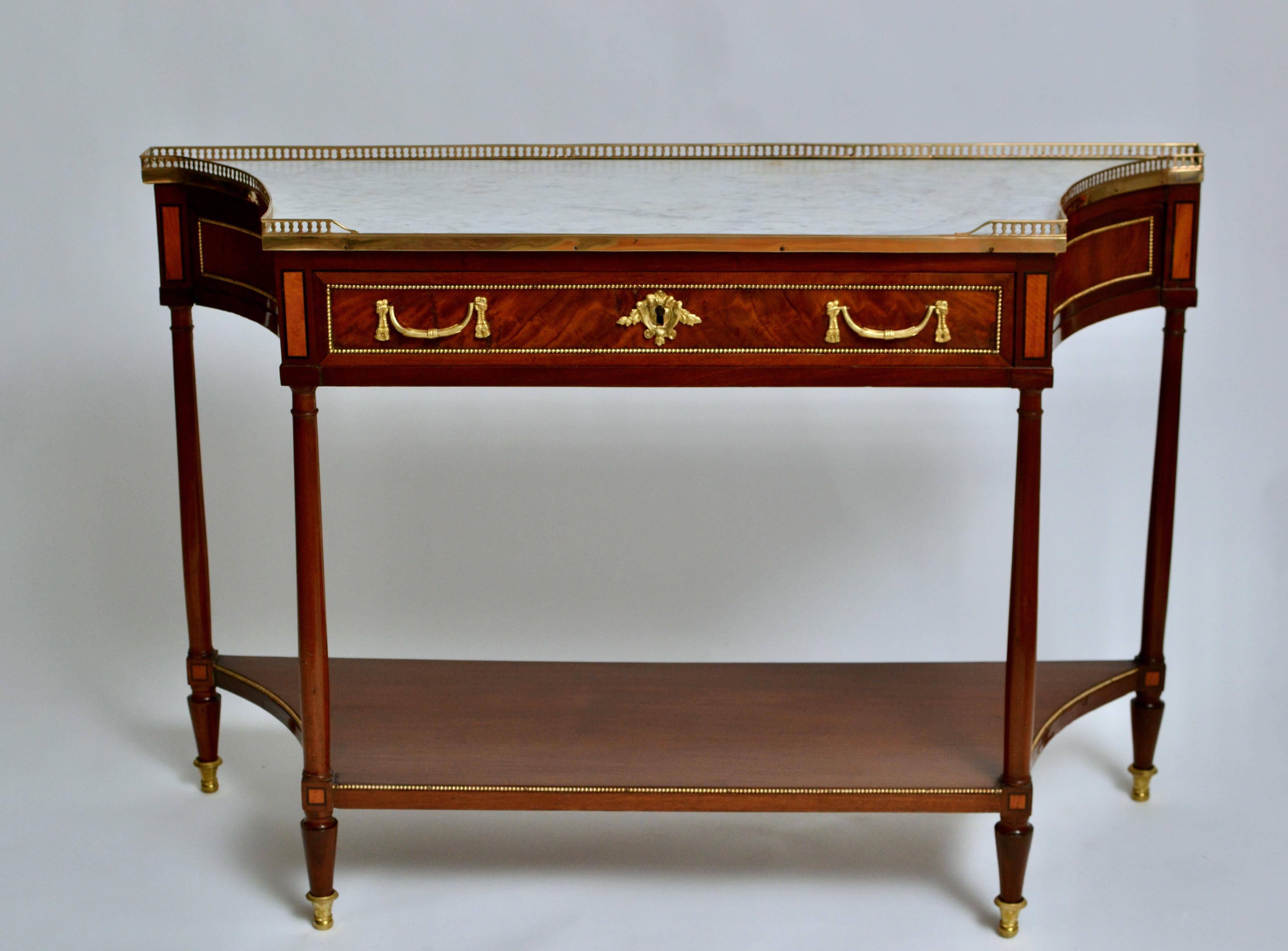 A fine Louis XVI gilt bronze mounted mahogany console desserte with a white marble top, 18th century.