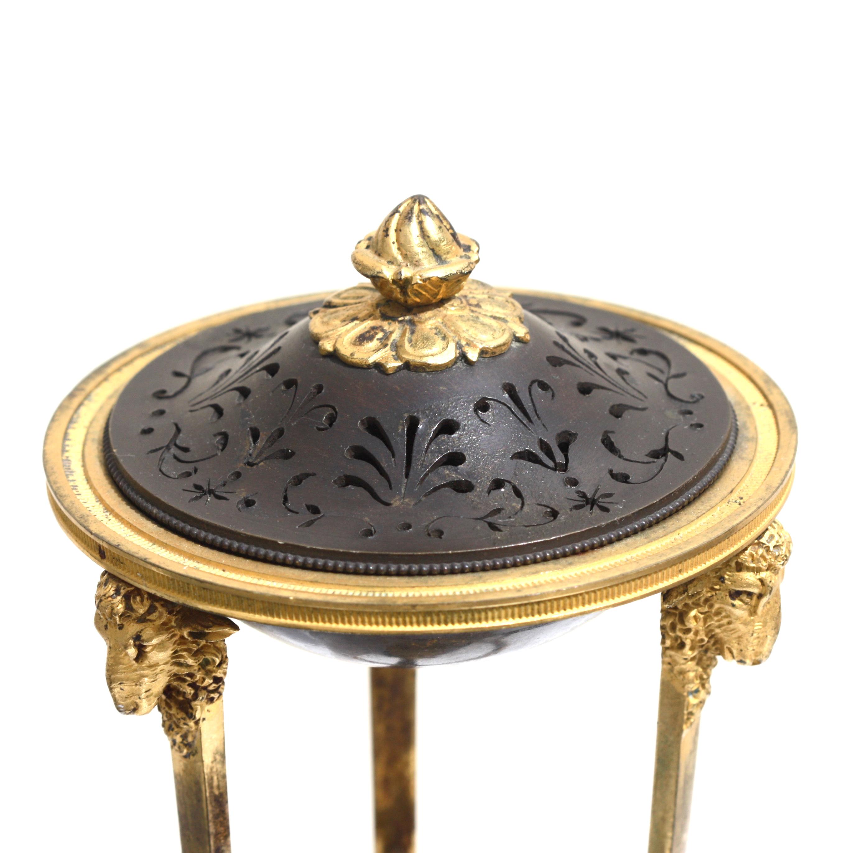 A Louis XVI ormolu and patinated bronze potpourri, raised on a triangular rouge marble base,
France, circa 1880,
Measures: Height 8.5 inches, width 3.75 inches.