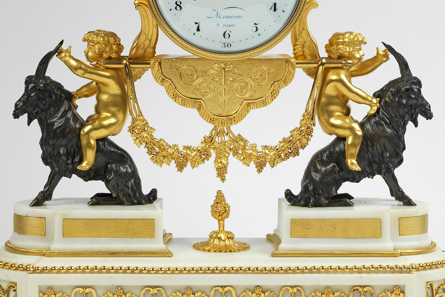 Pendule a La Bacchante

The drum shaped ormolu clock case which is surmounted by a figure of Bacchante is suspended between cupids sitting on seated goats eating grapes. The white enamel dial with Arabic numerals is signed Maniere a Paris. Resting