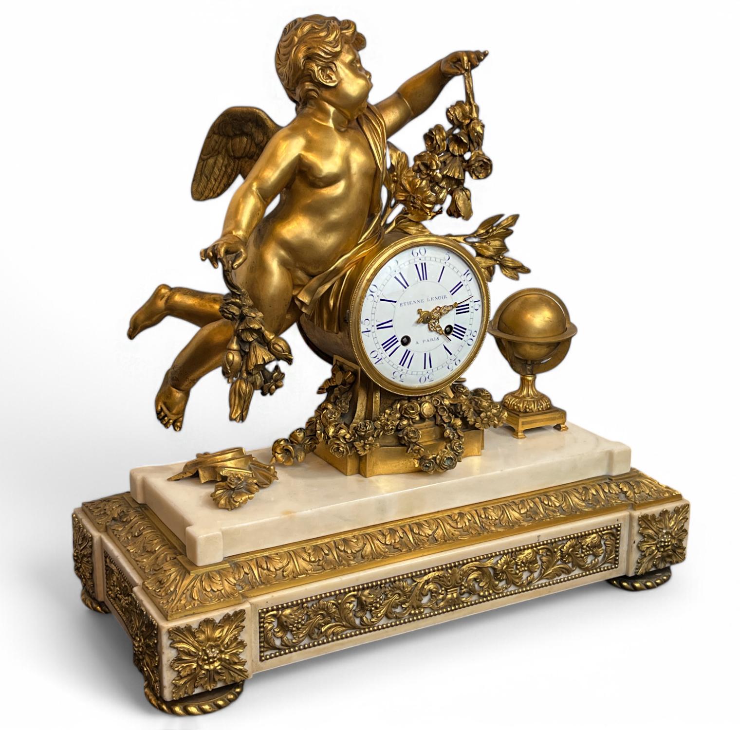 A Louis XVI Ormolu and White Marble Mantel Clock of Cupid 

A magnificent and large clock with gilt bronze Cupid mounted to the clock face. He is flanked by a painter's palette and a globe, while the clock is wrapped in a crisply cast floral wreath.