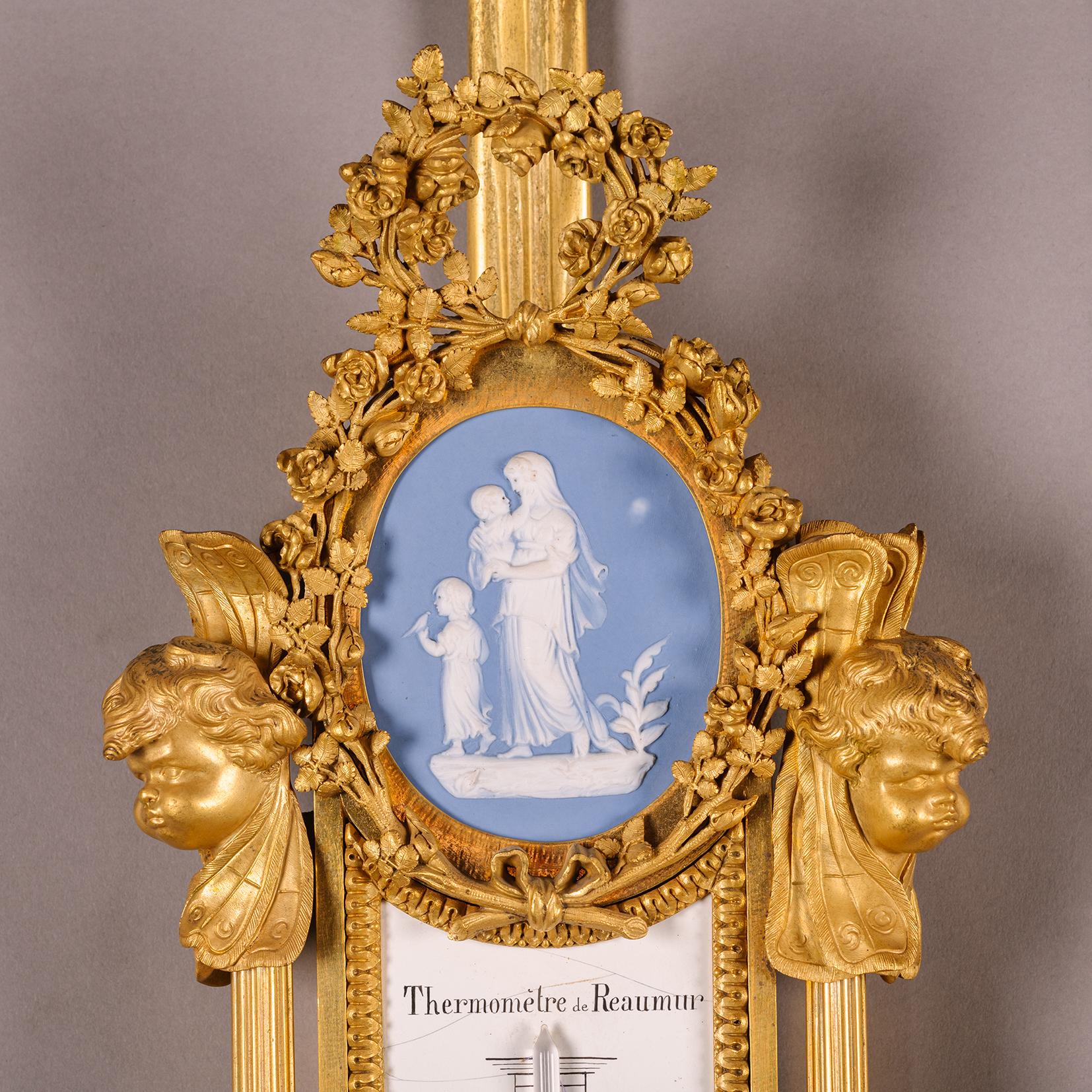 A Louis XVI Style Gilt-Bronze and Wedgwood Porcelain Cartel Clock and Companion Barometer, by Maison Millet, Paris, after the model attributed to Pierre Gouthière.

The clock dial is signed ‘Robin,’ and the barometer dial is signed ‘Radiguet / A