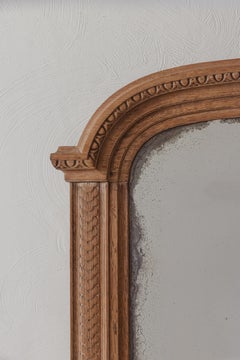 A Louis XVI-style carved oak pier mirror