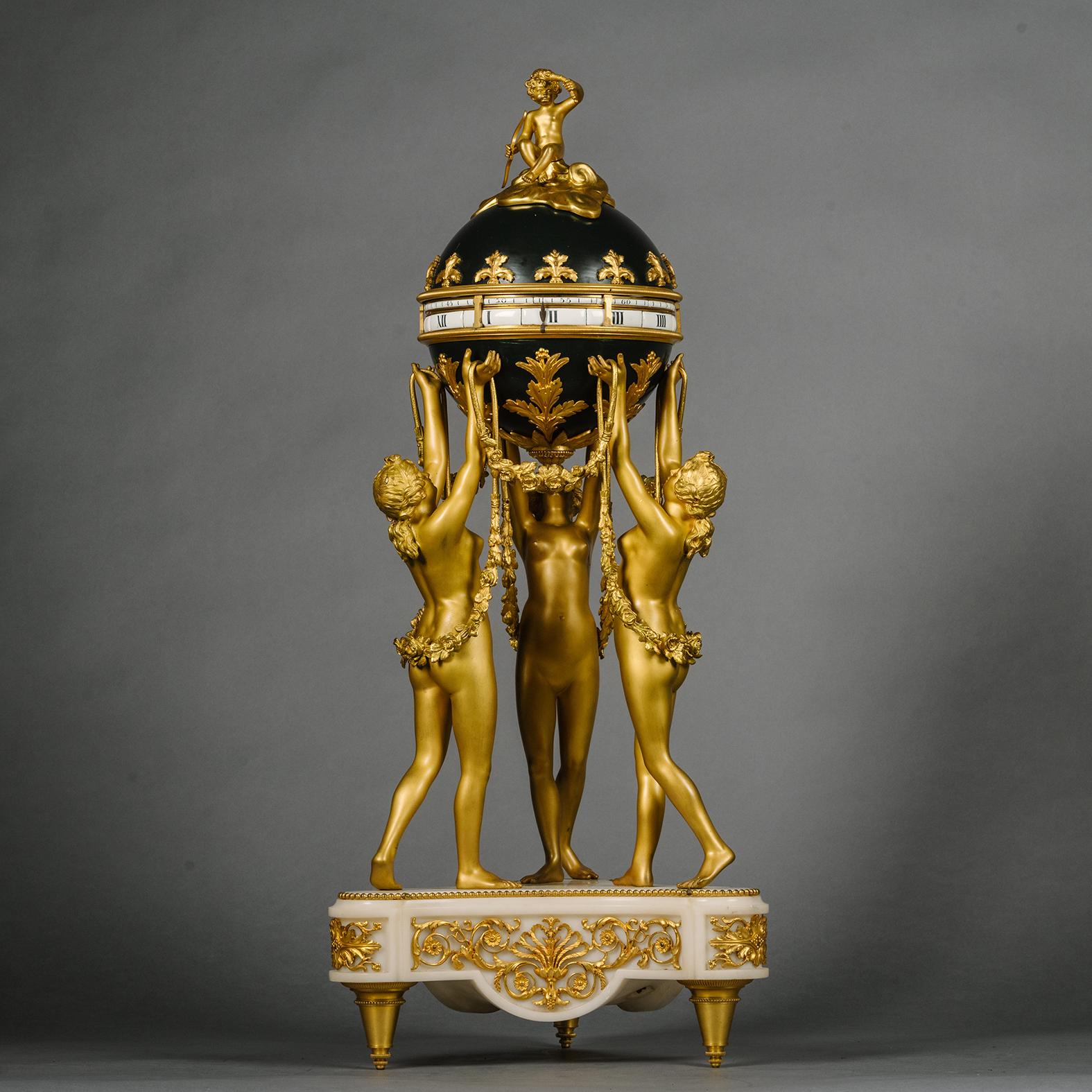 A Louis XVI Style Gilt and Patinated Bronze and Marble Clock Garniture, Comprising a 'Pendule à Cercles Tournants' Modelled with the Three Graces and a Pair of Cherub Four-Light Candelabra, By Jollet & Cie. 

Each stamped with cachet 'JOLLET & CIE /