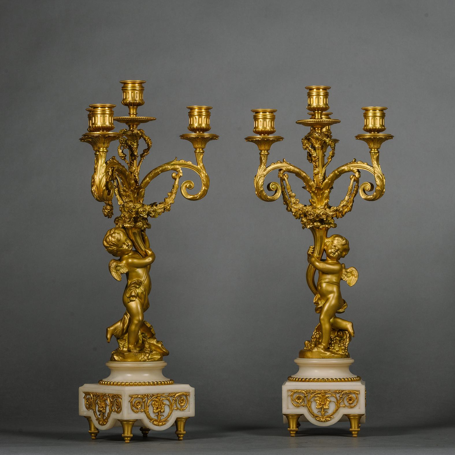 French A Louis XVI Style Gilt and Patinated Bronze and Marble Clock Garniture For Sale