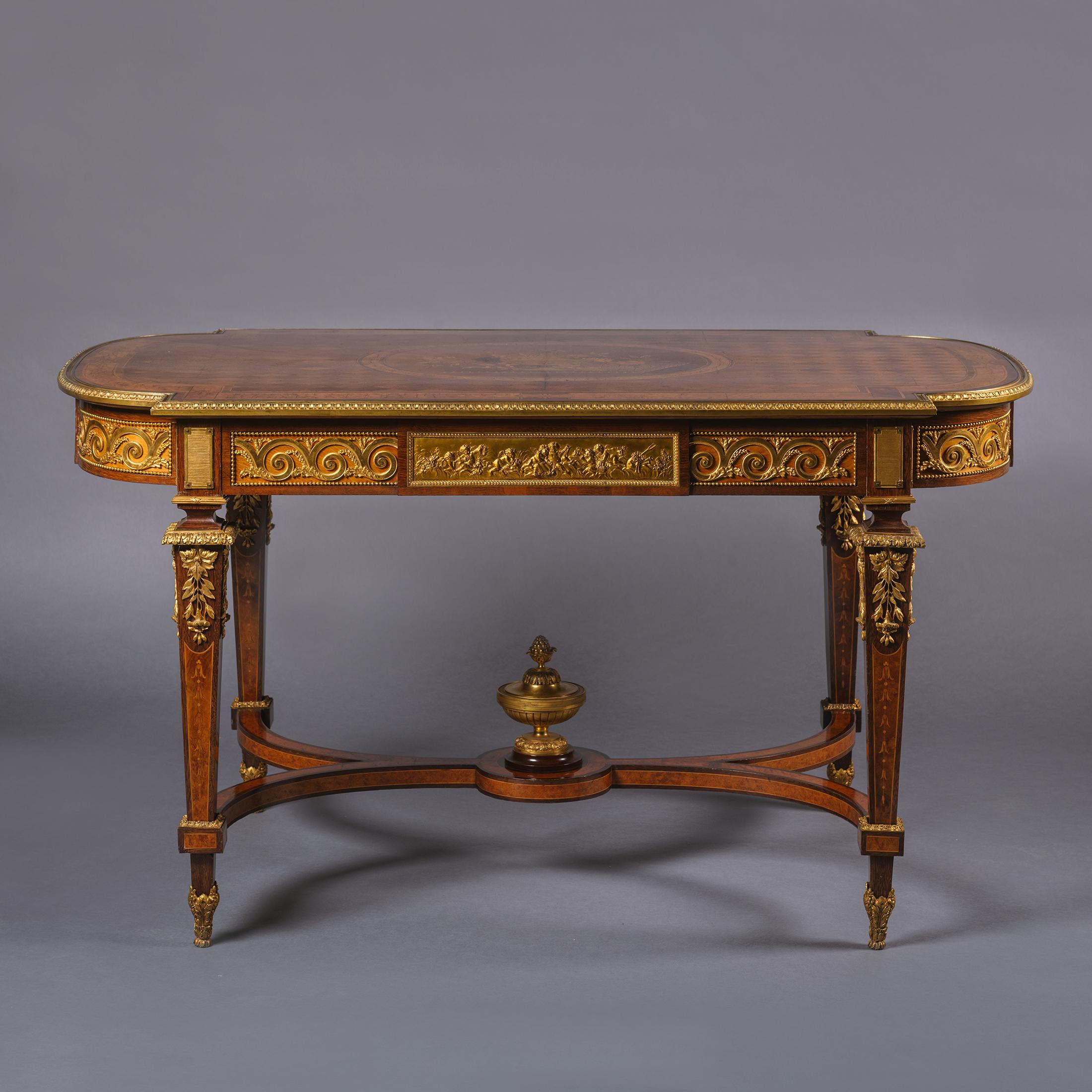 Mitteltisch im Stil Louis XVI aus vergoldeter Bronze und Intarsien.

Dieser beeindruckende Mitteltisch ist wunderschön mit Beschlägen aus Cuivre doré verziert. Das Oberteil hat einen rautenförmigen Parkettgrund, der eine ovale Platte mit einem