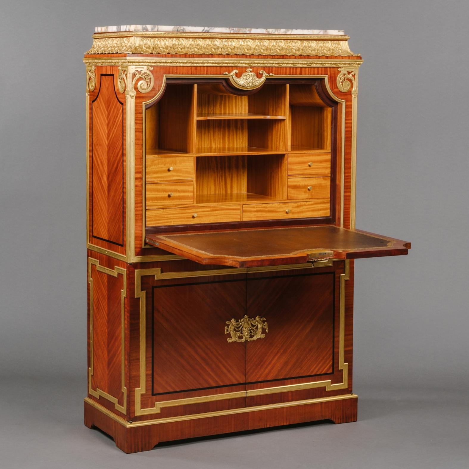 An Impressive Louis XVI style gilt-bronze mounted secrétaire à Abattant, In The Manner Of André Charles Boulle.

This drop-front writing cabinet or secrétaire à abattant is finished in beautiful veneers with radiating figured panels. The inset