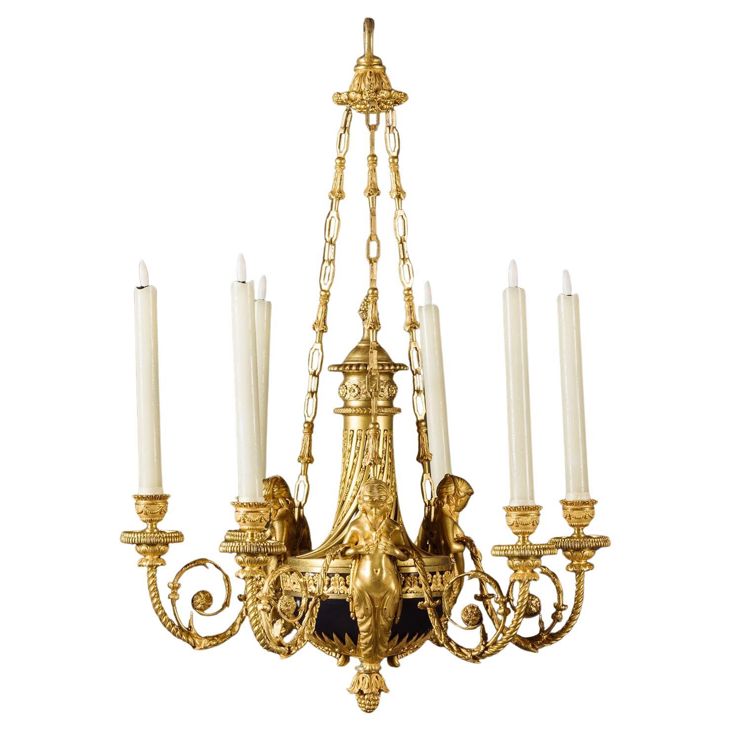 Araña de seis luces de bronce dorado estilo Luis XVI "Aux Termes".