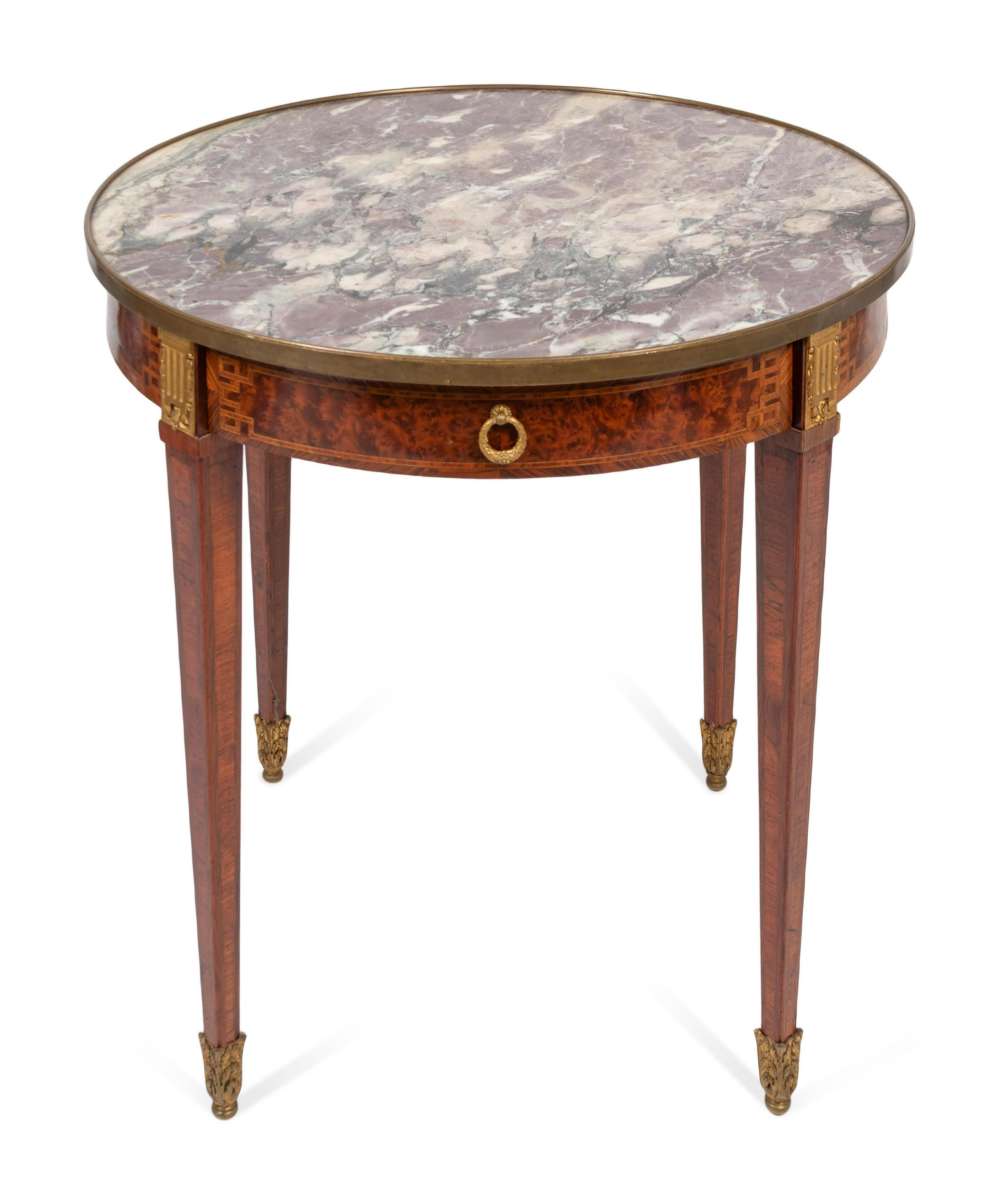 A very fine and striking Louis XVI style marquetry inlaid and Breche Violette marble top Bouillotte table, France, circa 1880
Dimensions: Height 27 1/2